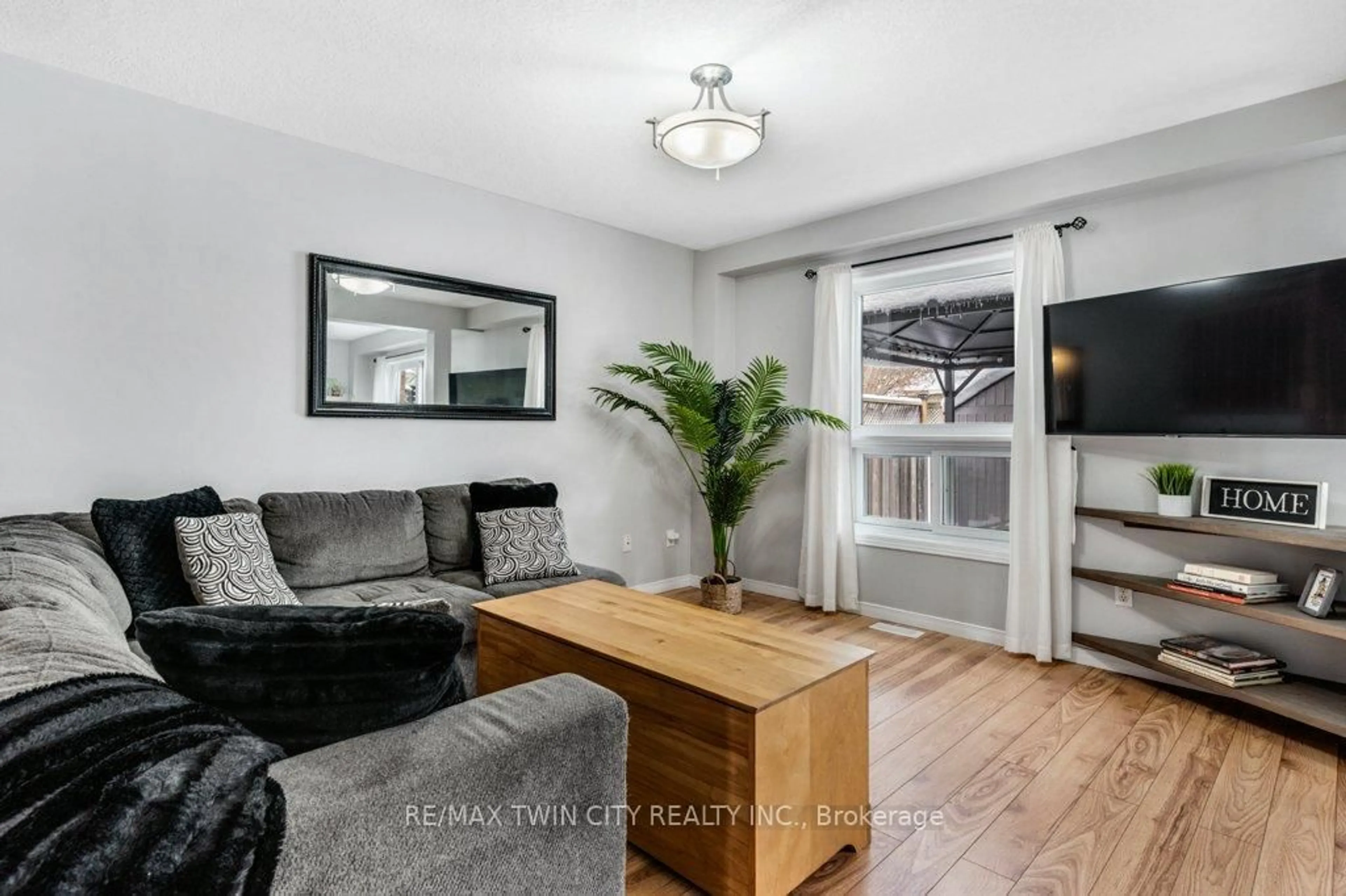 Living room with furniture, wood/laminate floor for 102 Marston Cres, Cambridge Ontario N3C 4G4