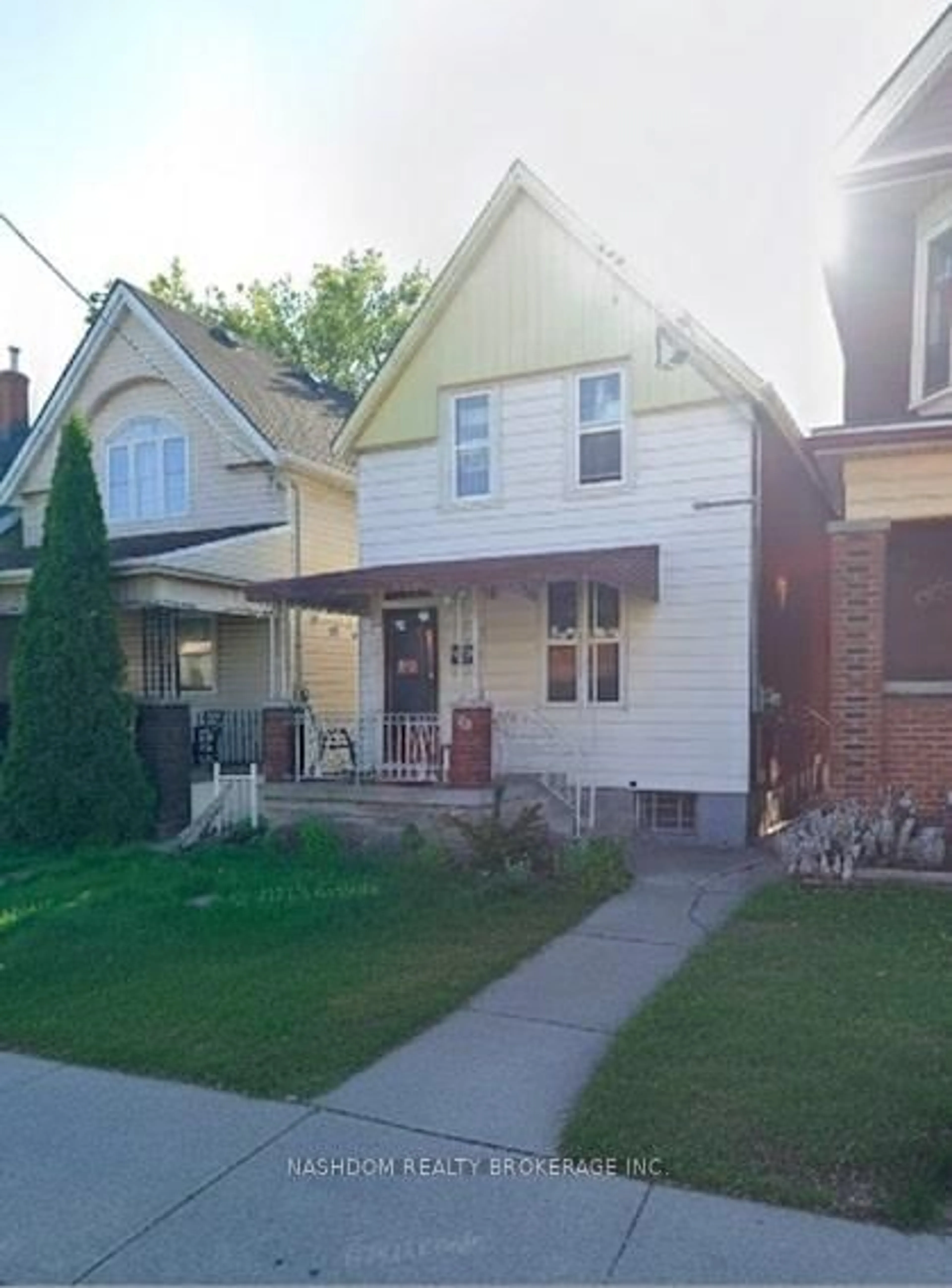 Home with vinyl exterior material, street for 100 Sherman Ave, Hamilton Ontario L8L 6M5