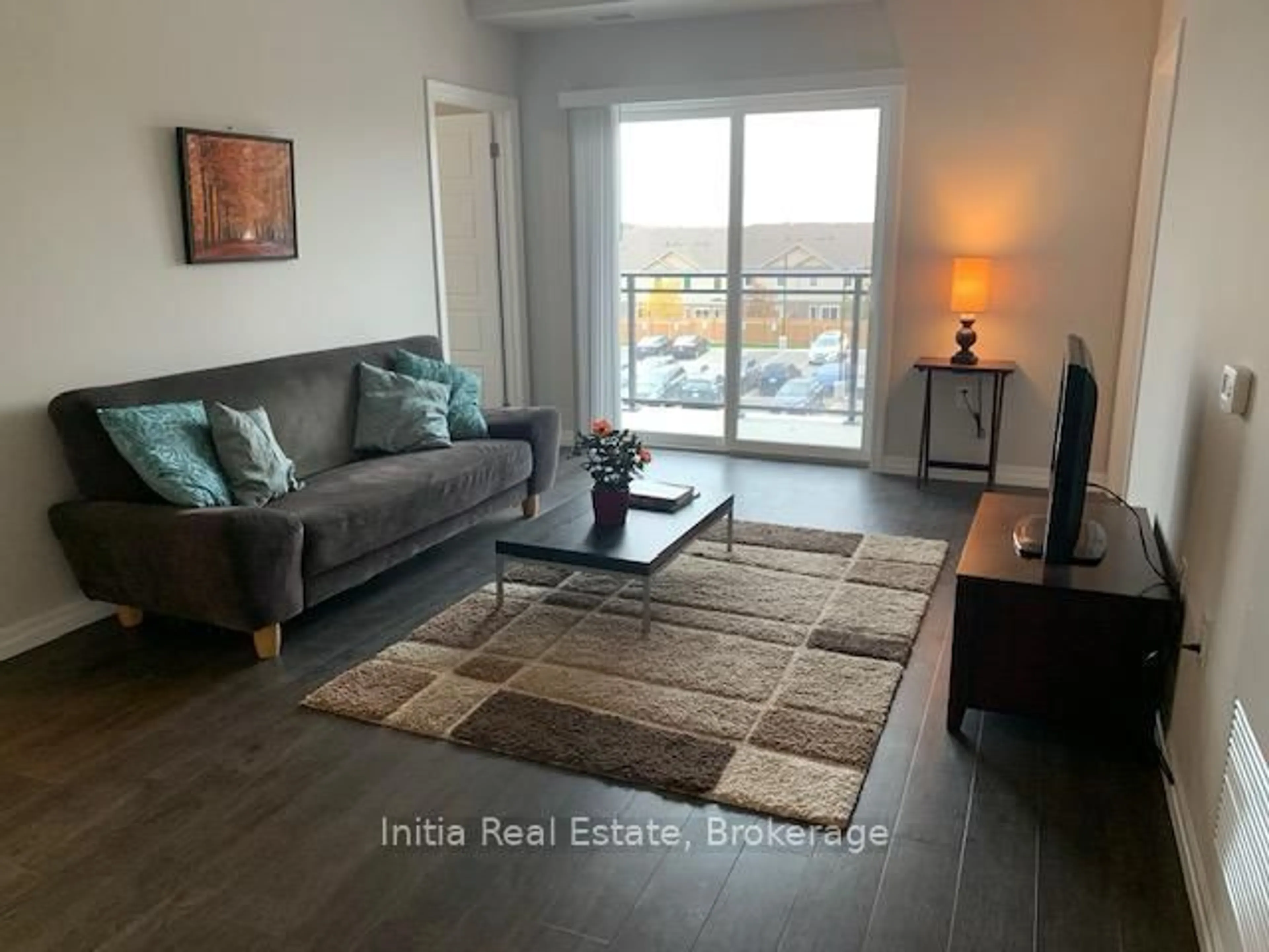 Living room with furniture, wood/laminate floor for 35 Kingsbury Sq #323, Guelph Ontario N1L 0J4