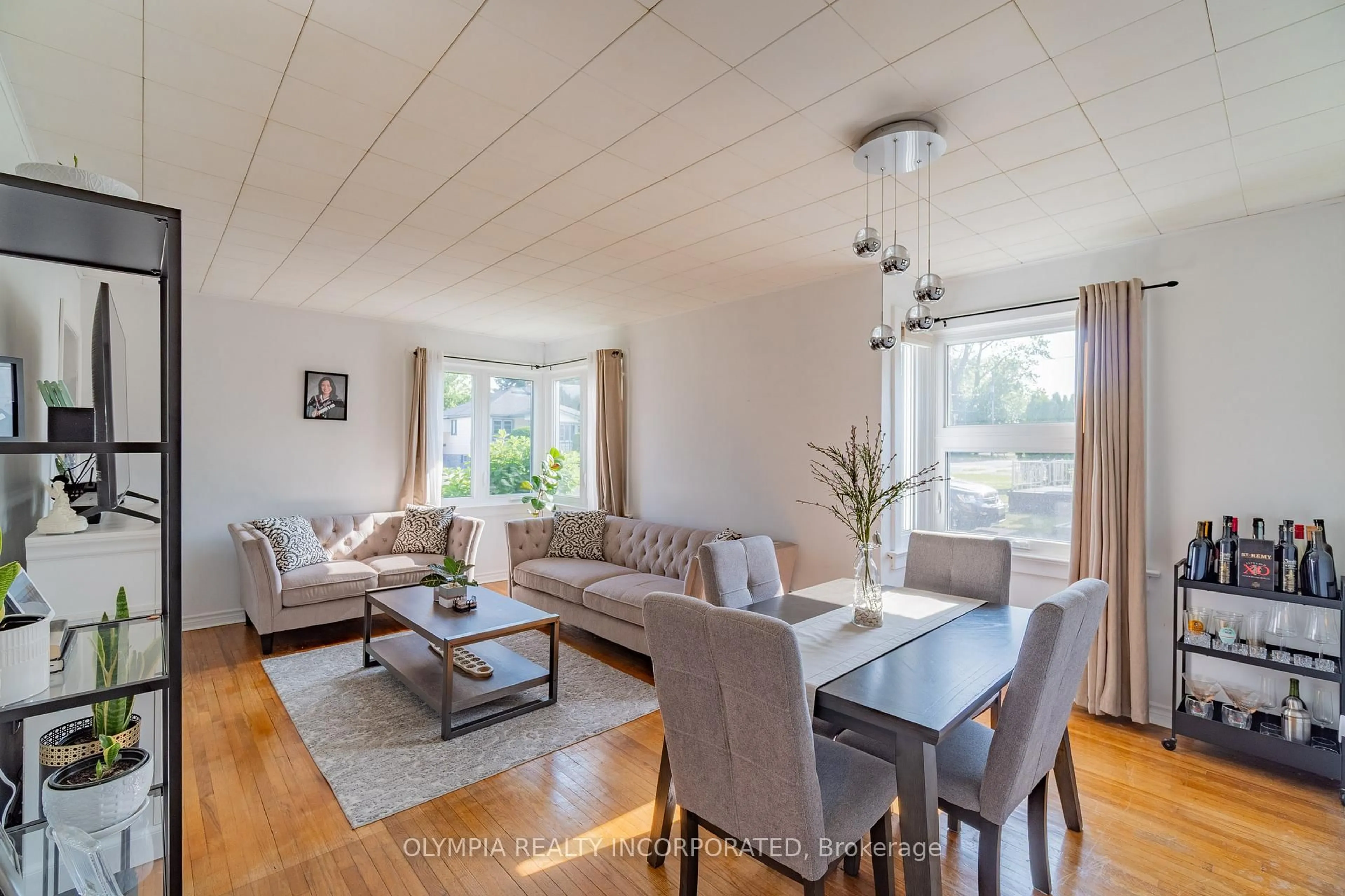 Living room with furniture, wood/laminate floor for 6129 Keith St, Niagara Falls Ontario L2J 1K1