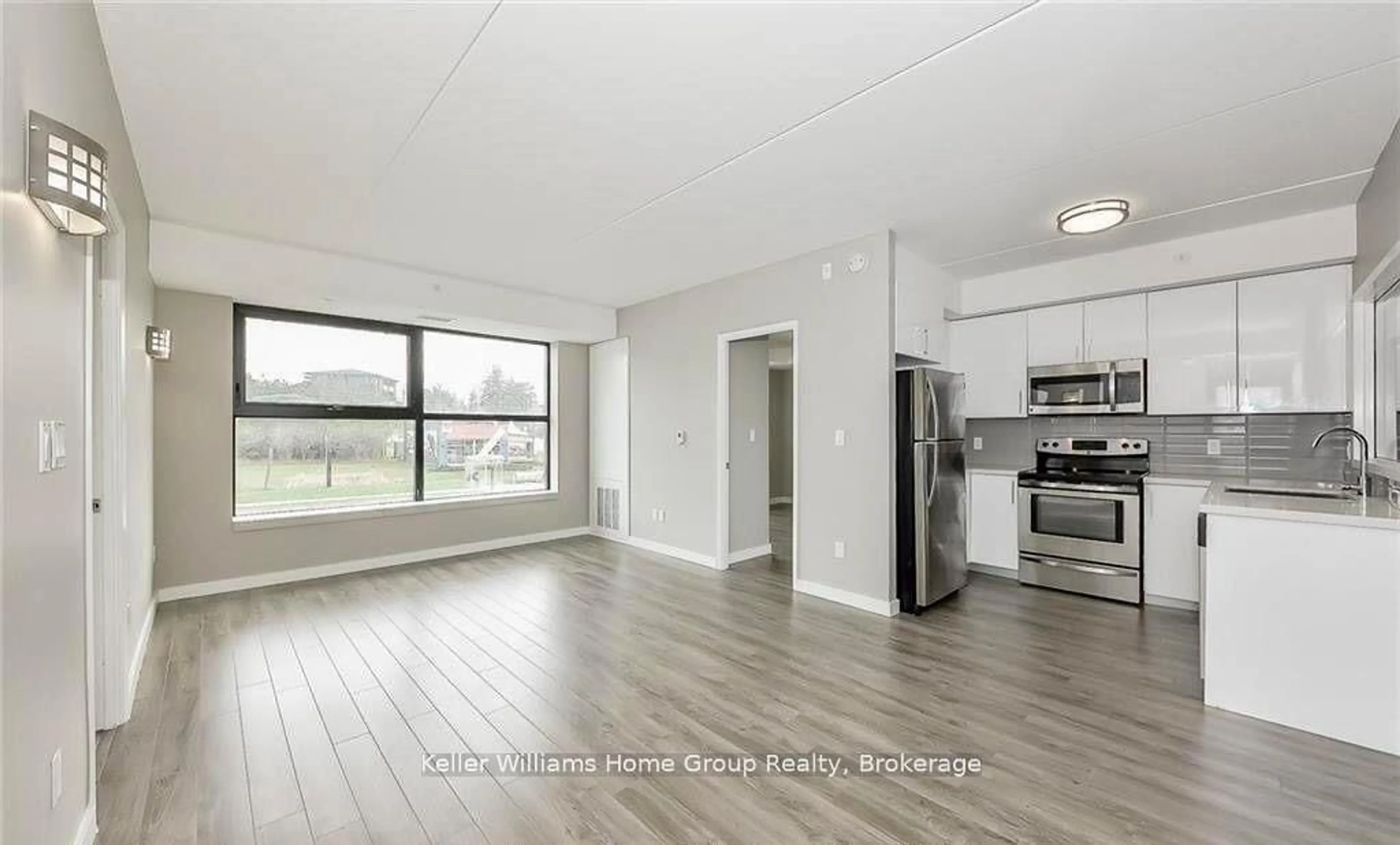 Open concept kitchen, wood/laminate floor for 1291 Gordon St #417, Guelph Ontario N1G 5E7