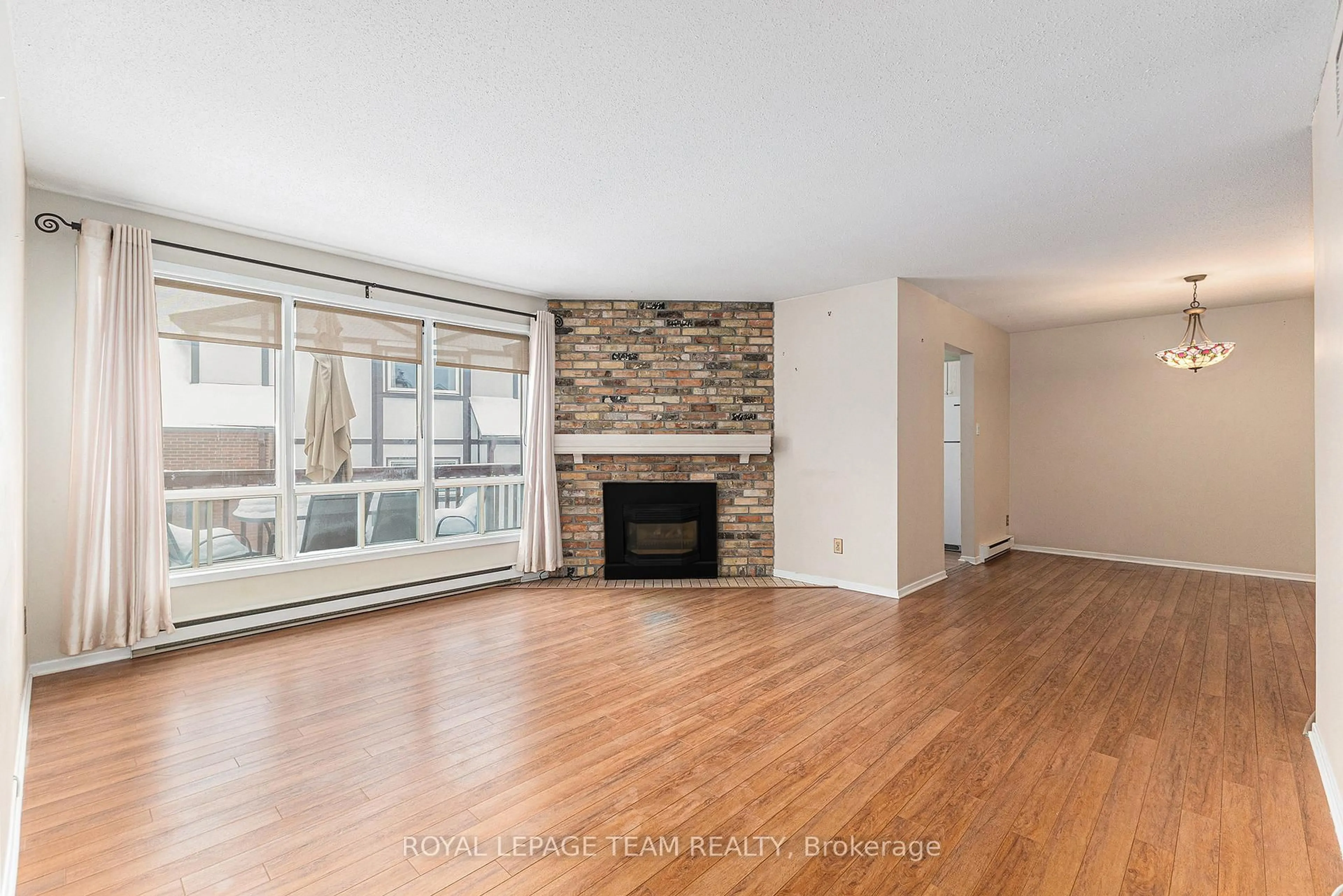 Living room with furniture, wood/laminate floor for 7 Harness Lane #C, Ottawa Ontario K2M 1E1