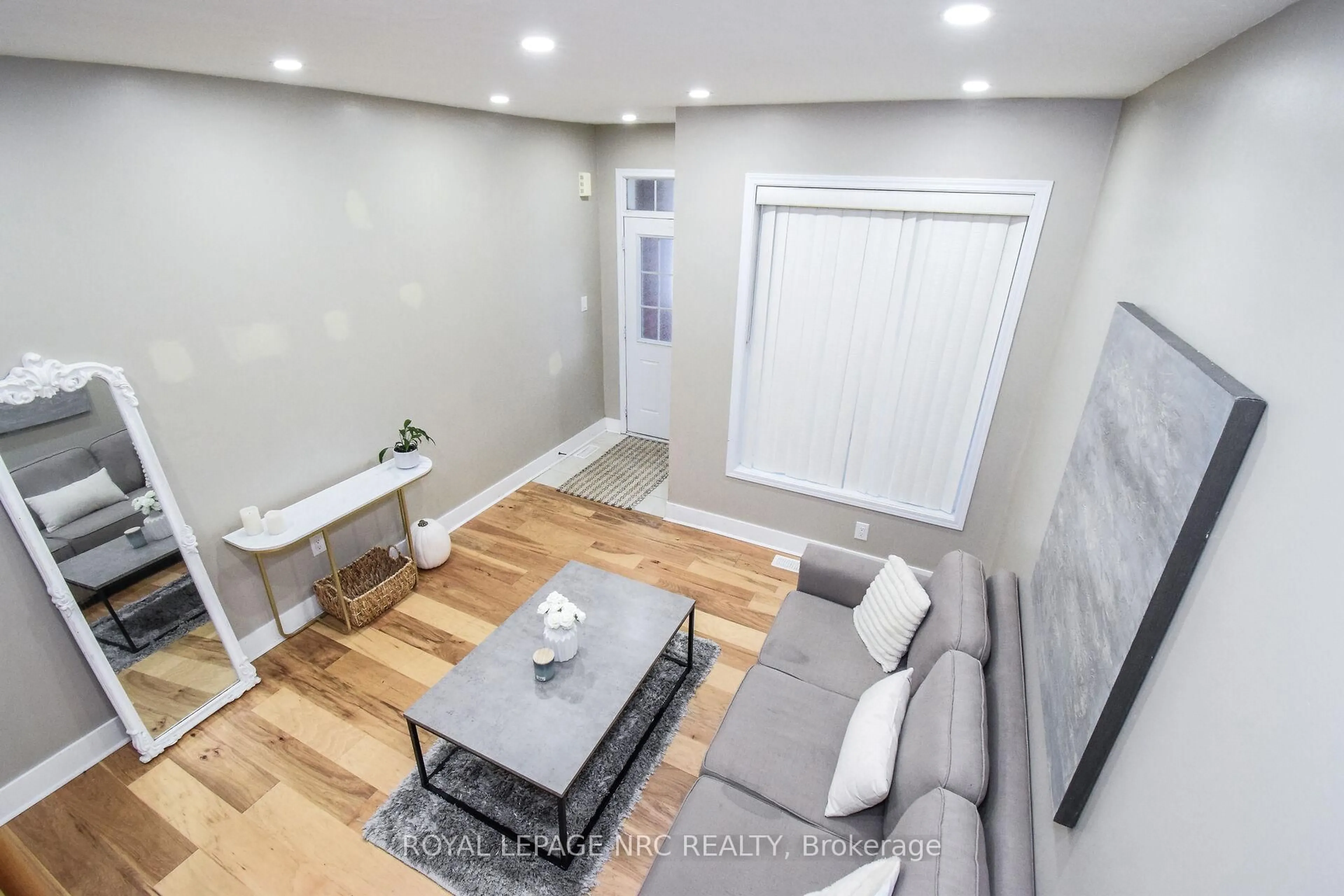 Living room with furniture, wood/laminate floor for 7794 Sassafras Tr, Niagara Falls Ontario L2H 0N5