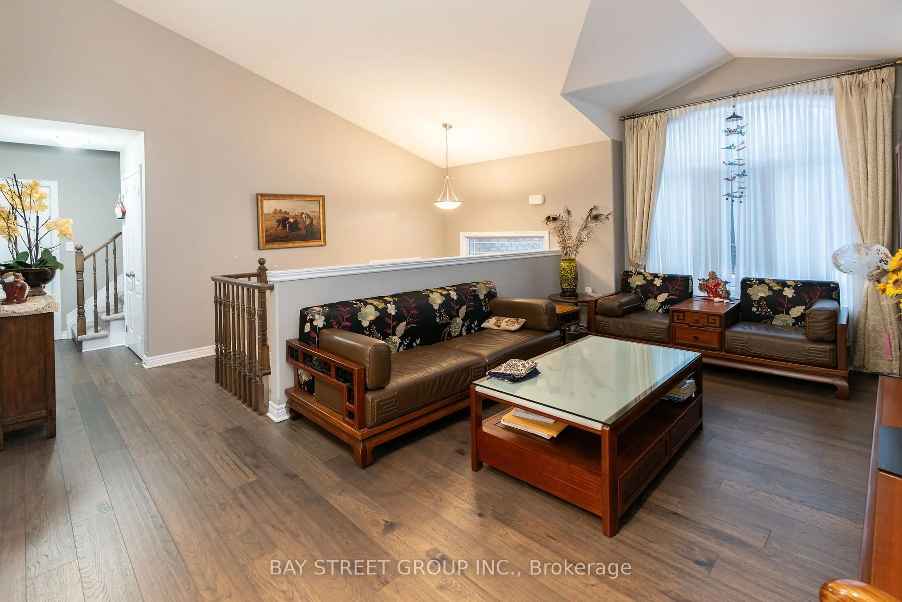 Living room with furniture, wood/laminate floor for 7833 Oldfield Rd, Niagara Falls Ontario L2G 3J8