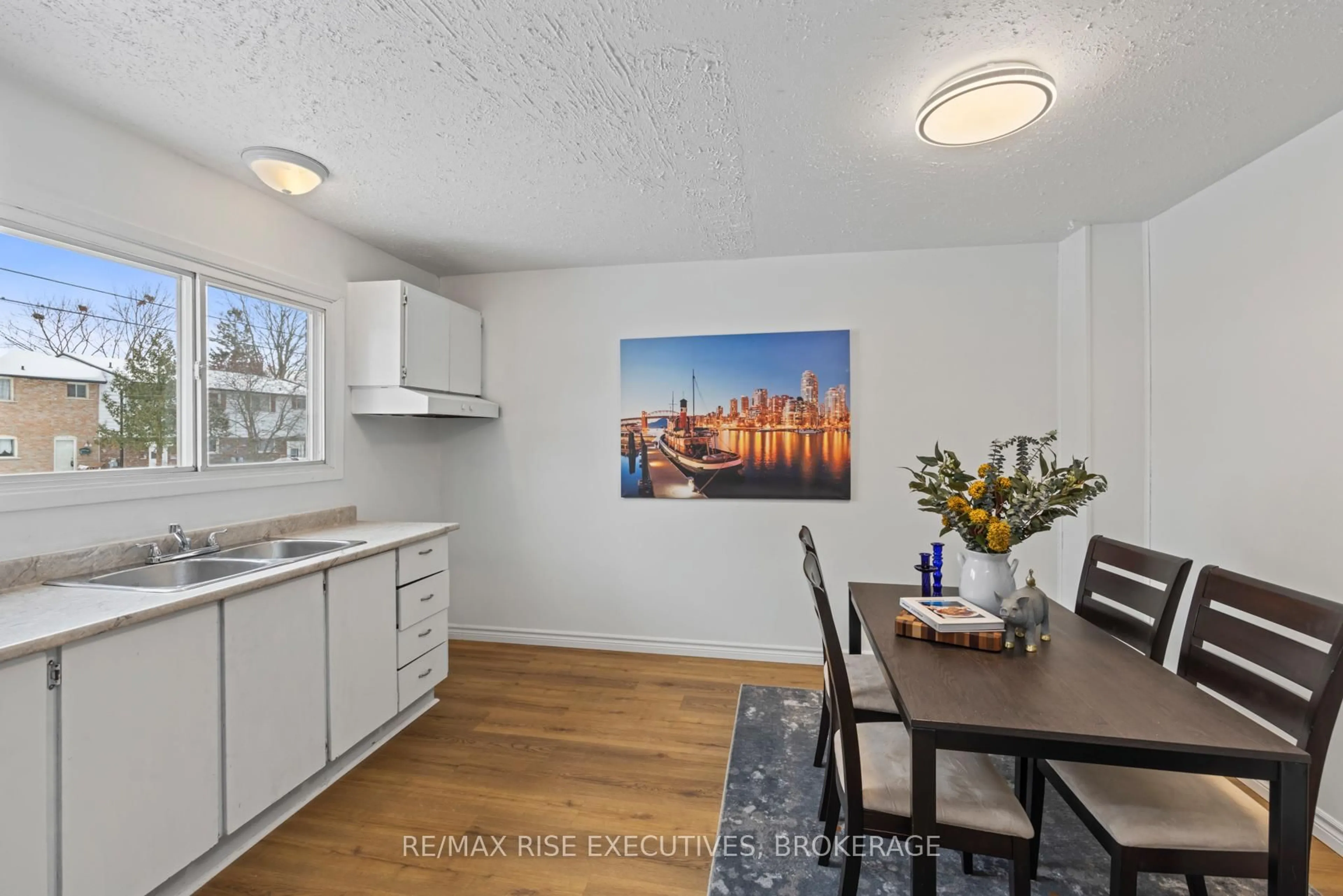 Open concept kitchen, wood/laminate floor for 777 Ashwood Dr #173, Kingston Ontario K7M 6X7