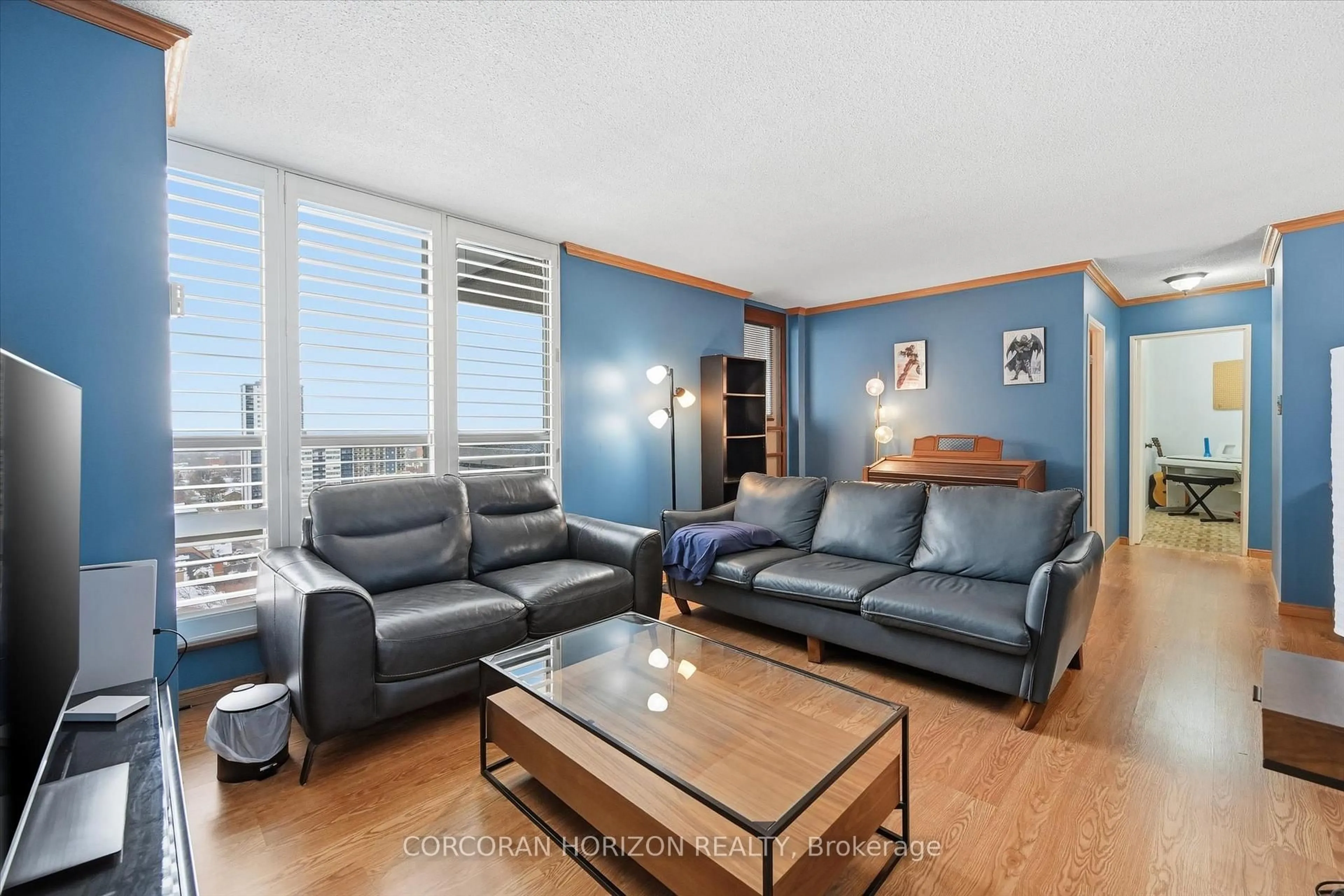 Living room with furniture, wood/laminate floor for 222 Jackson St #1202, Hamilton Ontario L8P 4S5
