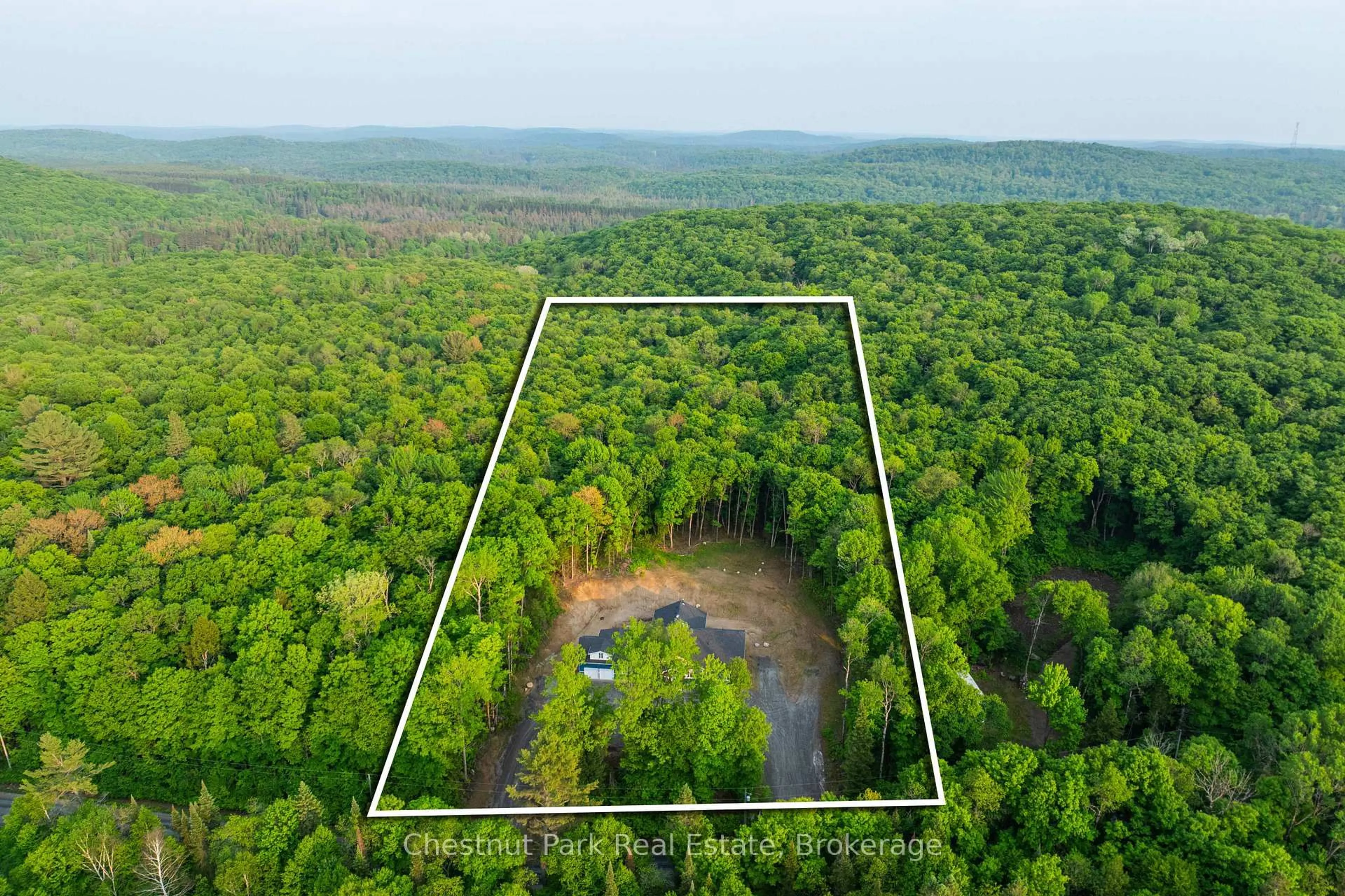 A pic from outside/outdoor area/front of a property/back of a property/a pic from drone, forest/trees view for 1153 Deer Lake Rd, Perry Ontario P0A 1Z0