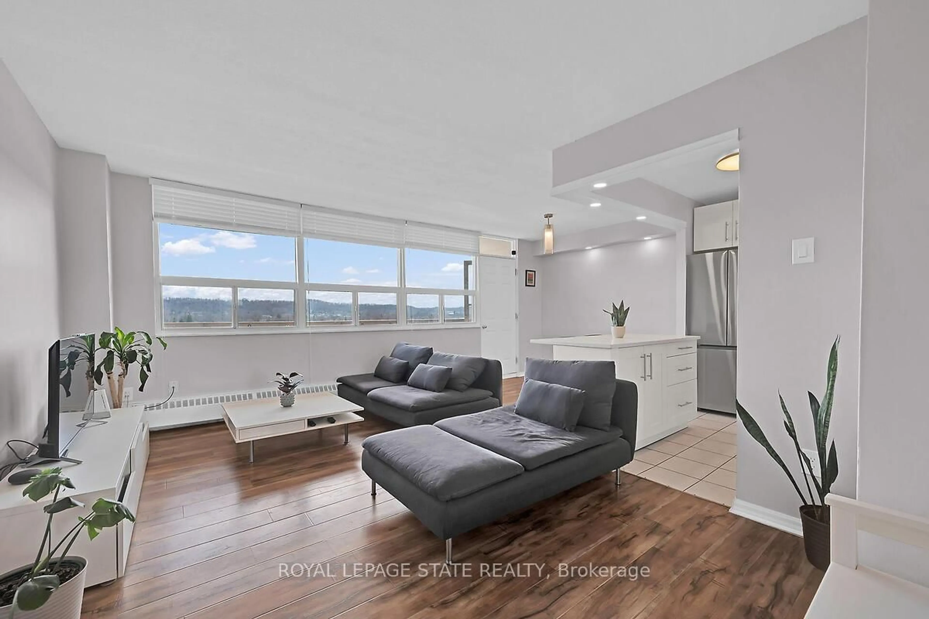 Living room with furniture, wood/laminate floor for 15 Albright Rd #811, Hamilton Ontario L8K 5J2