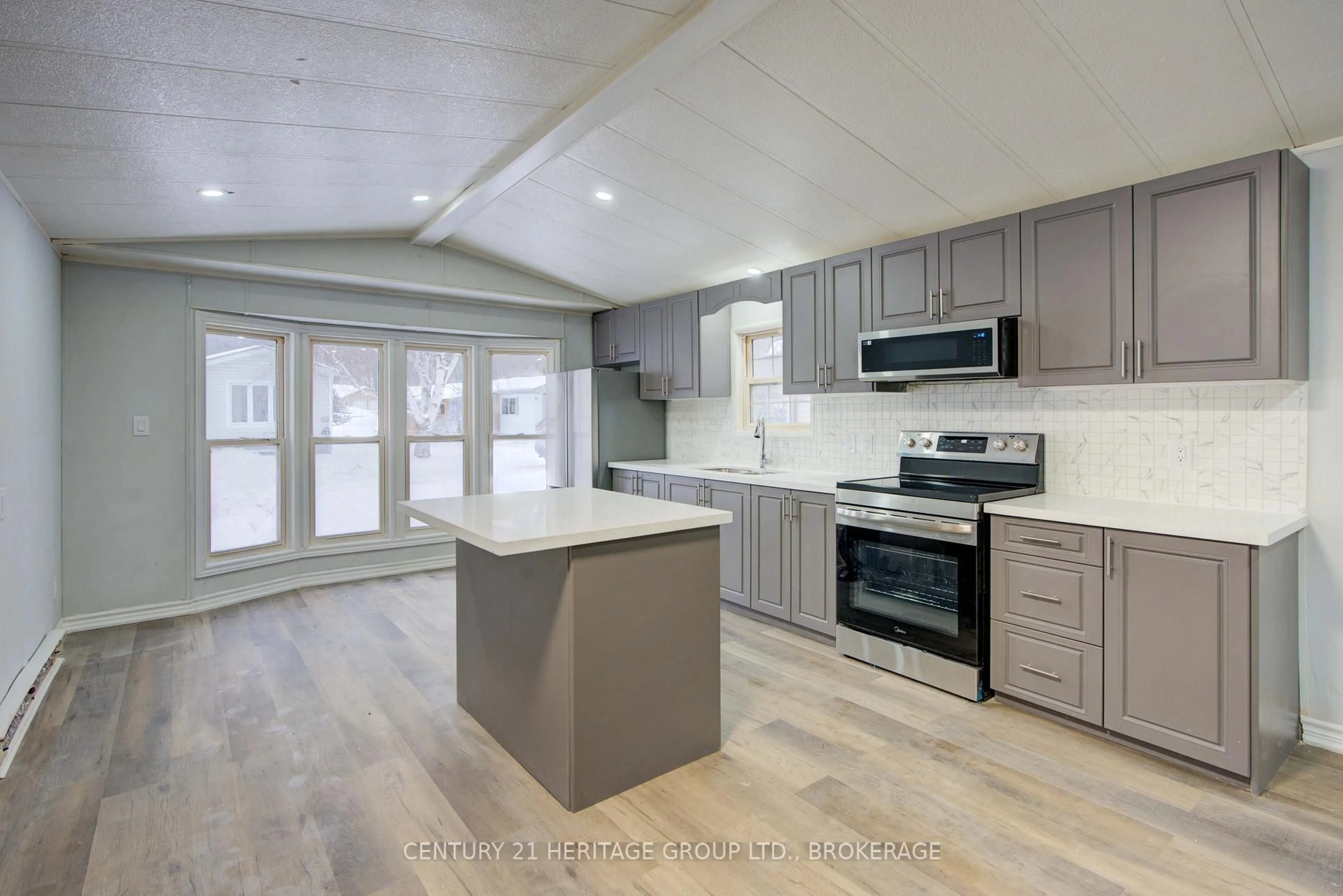 Open concept kitchen, wood/laminate floor for 227 Big Hill Rd #35, Leeds and the Thousand Islands Ontario K0H 2N0