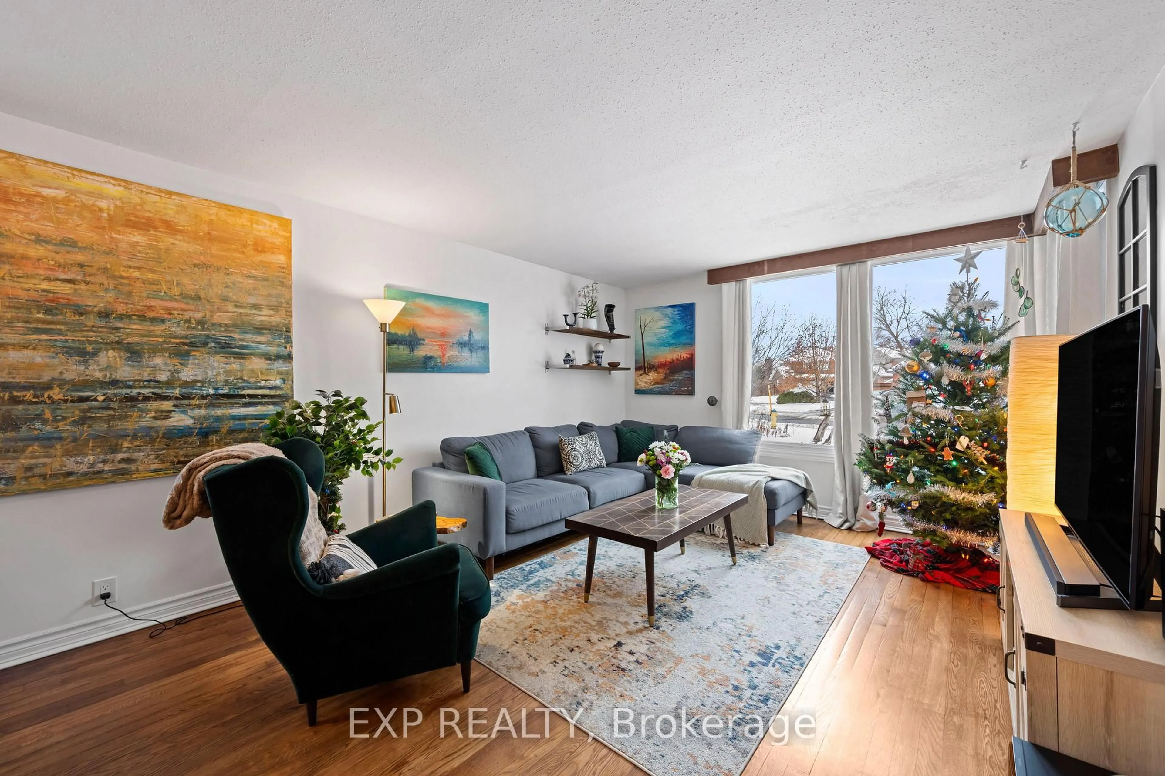 Living room with furniture, wood/laminate floor for 26 Leeming Dr, Ottawa Ontario K2H 5P7