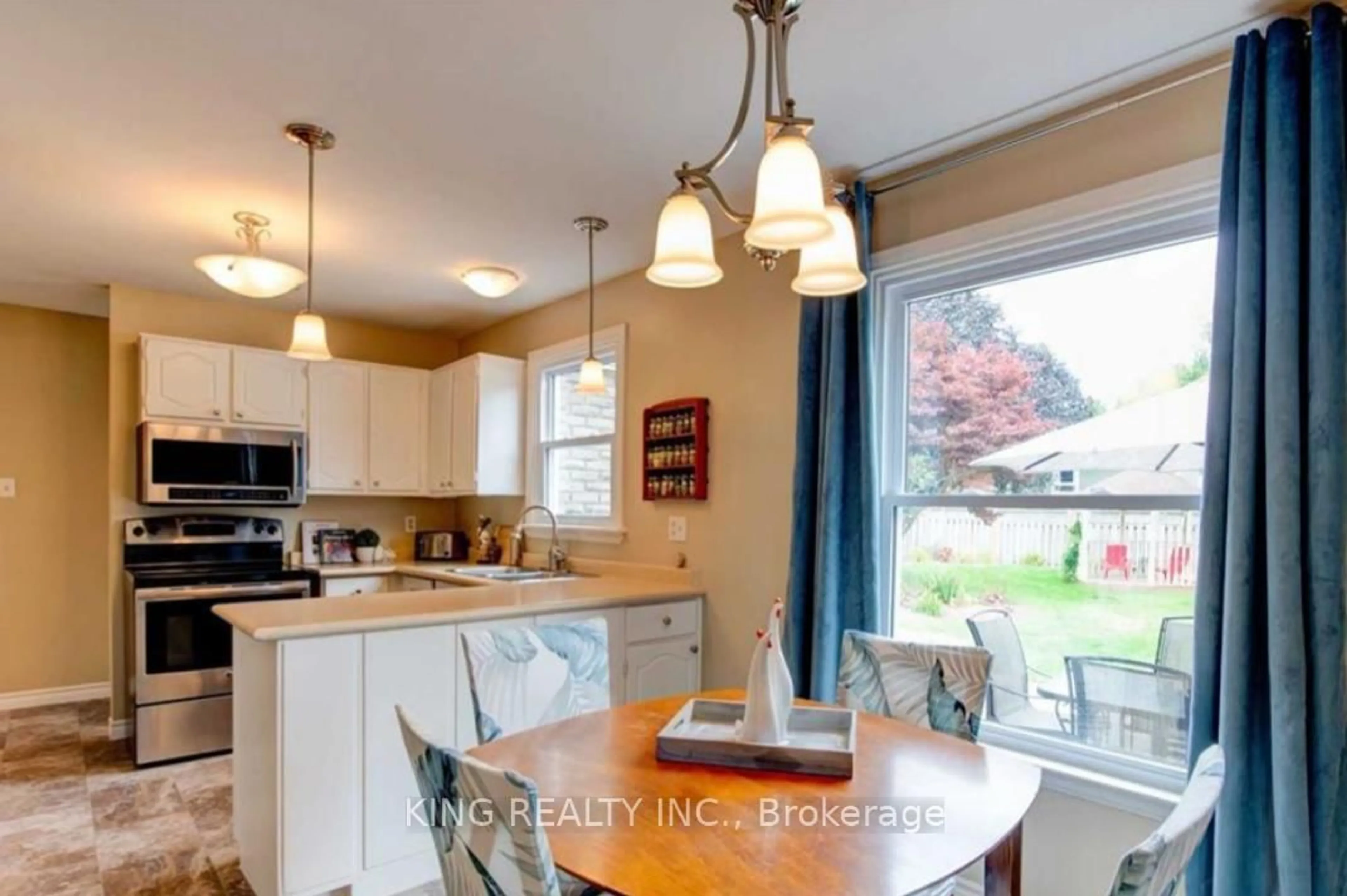 Open concept kitchen, wood/laminate floor for 960 Farnham Rd, London South Ontario N6K 1S1