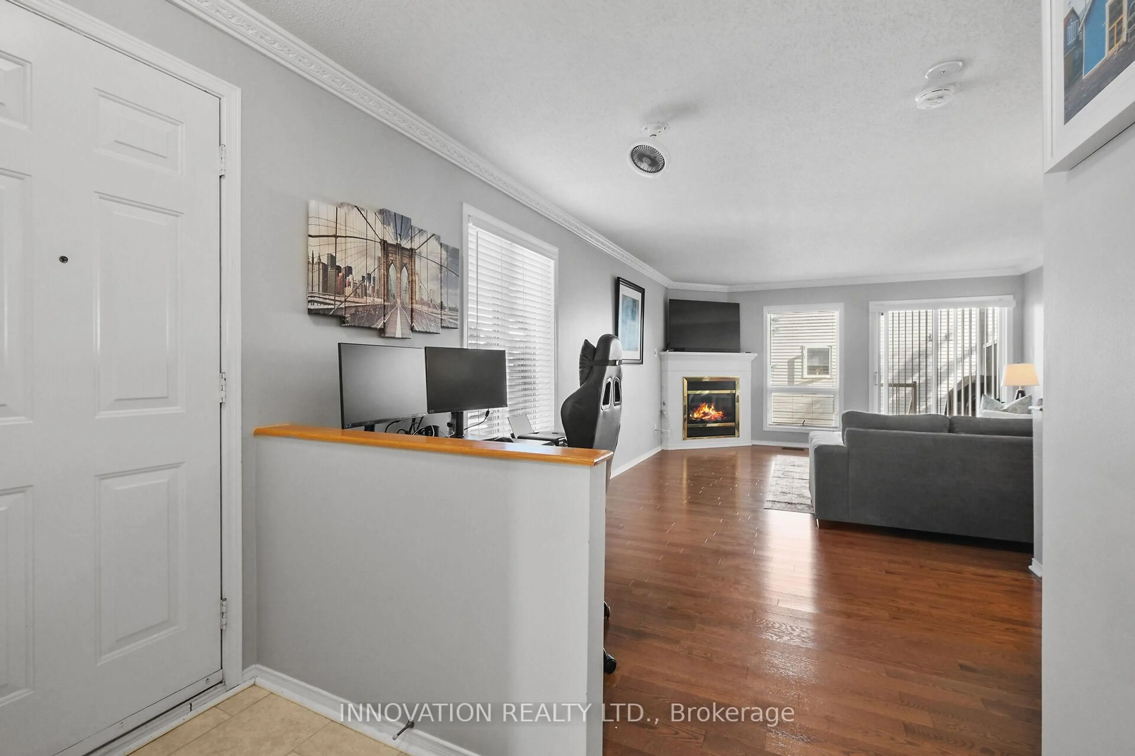 Living room with furniture, wood/laminate floor for 57 Waterbridge Dr, Ottawa Ontario K2G 6T9