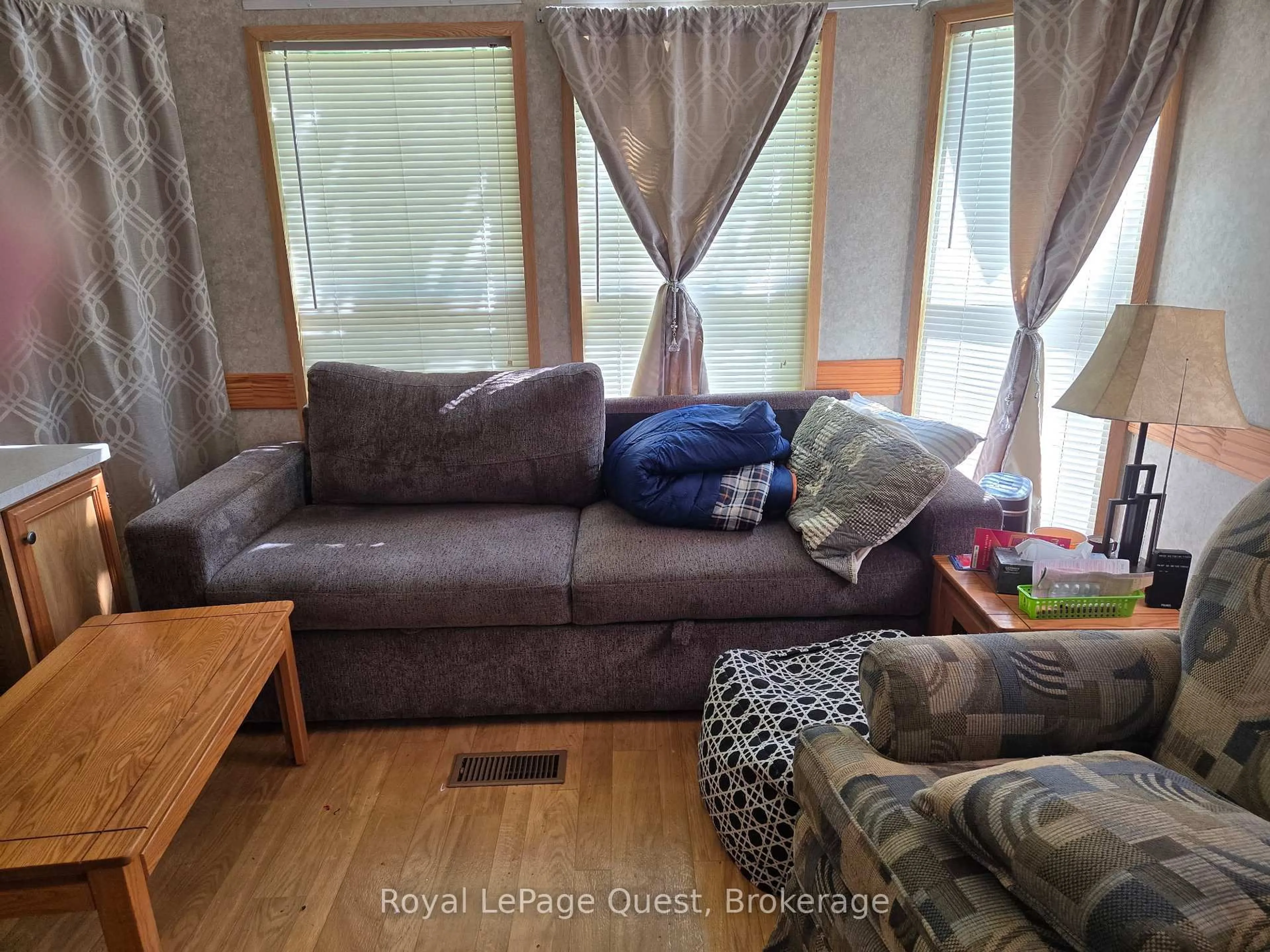 Living room with furniture, wood/laminate floor for 1005 Stephens Bay Rd #22, Bracebridge Ontario P1L 1X2