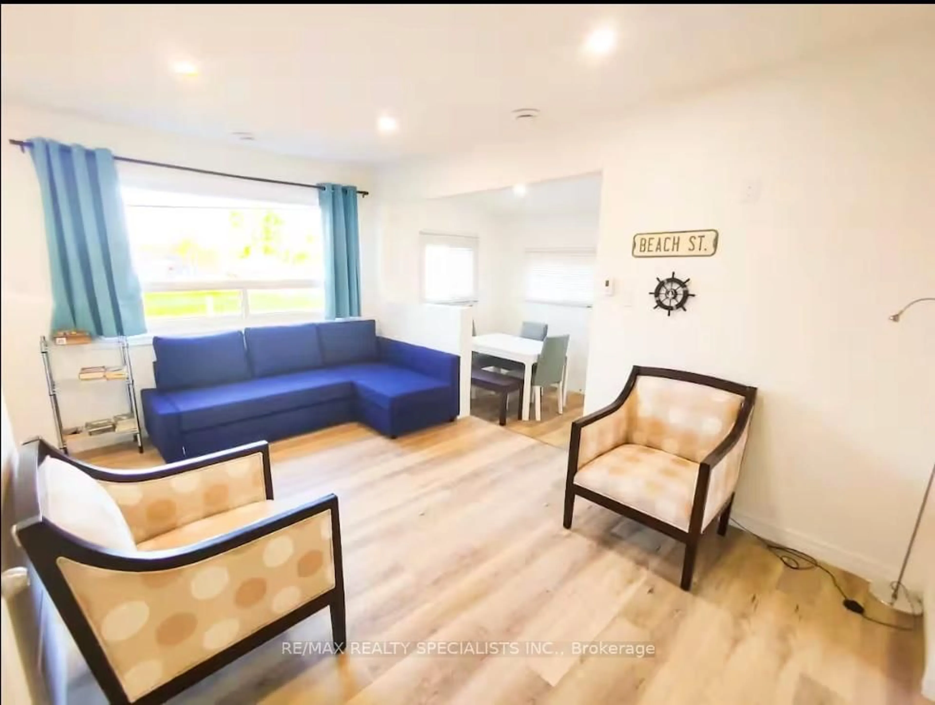 Living room with furniture, wood/laminate floor for 12209 Lakeshore Rd, Wainfleet Ontario L0S 1V0