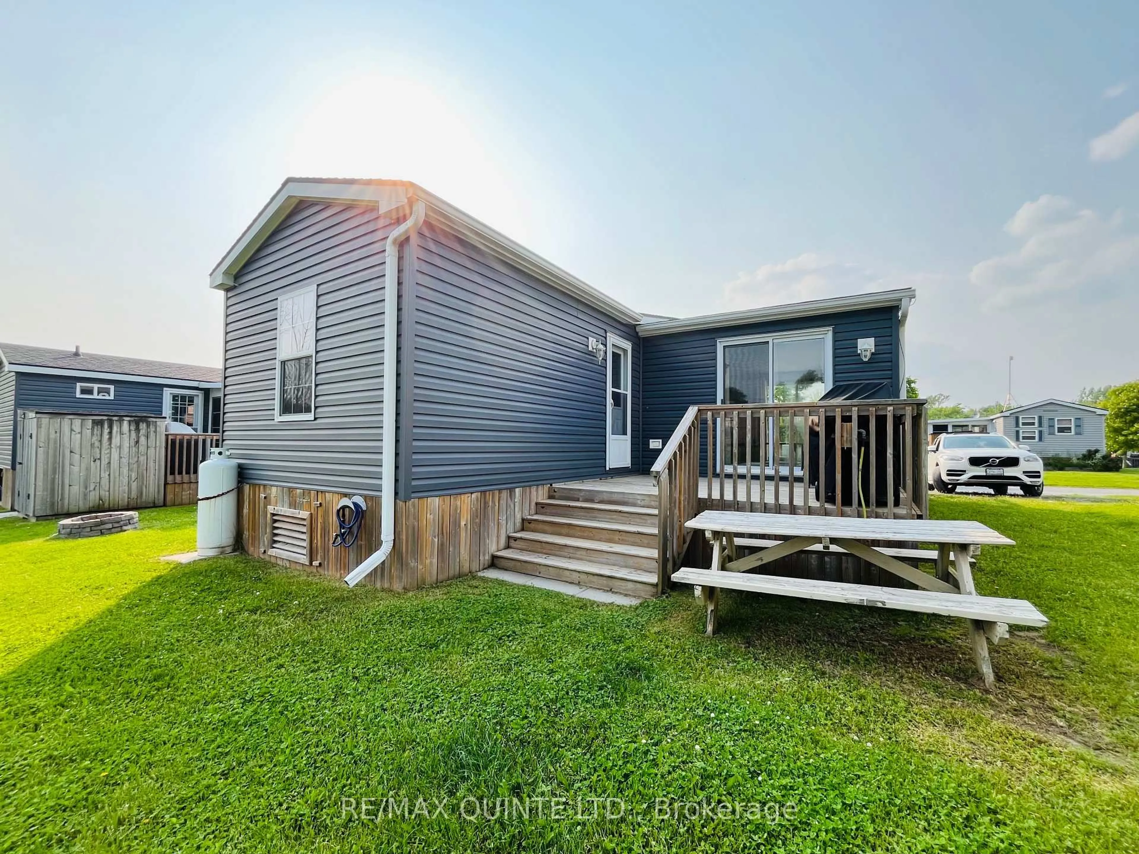 A pic from outside/outdoor area/front of a property/back of a property/a pic from drone, water/lake/river/ocean view for 486 County Road 18 #8 Cricket Ln, Prince Edward County Ontario K0K 1P0