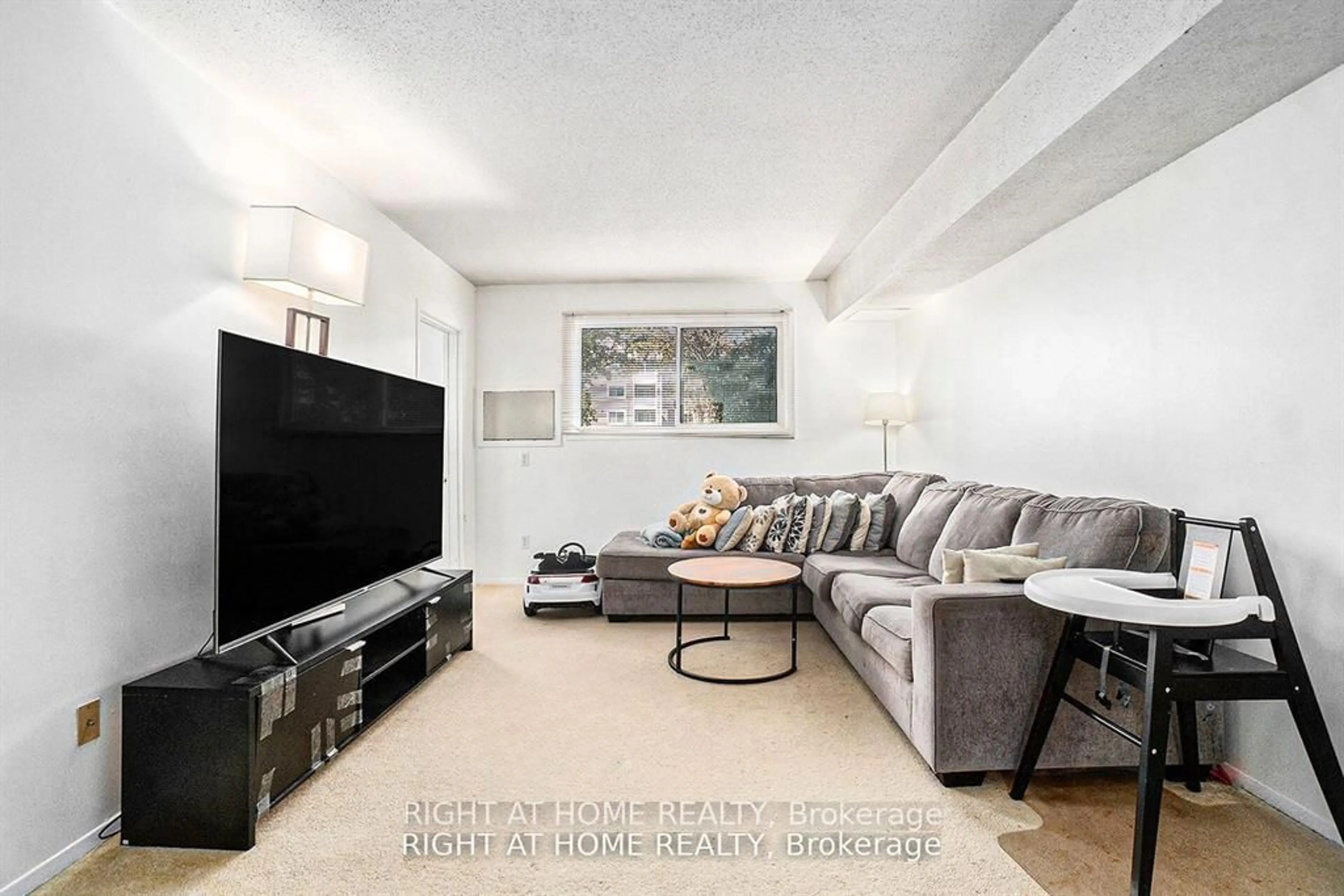 Living room with furniture, unknown for 318 Lorry Greenberg Dr #107, Ottawa Ontario K1T 2R5