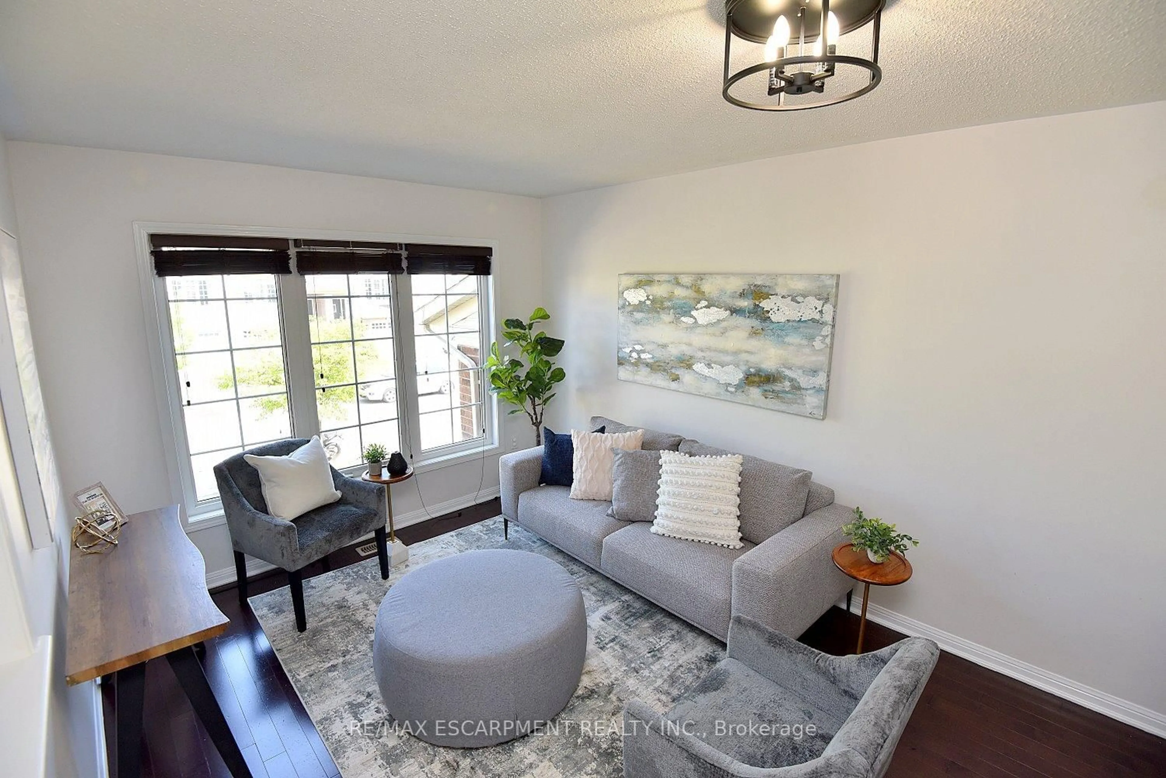 Living room with furniture, wood/laminate floor for 45 Ohara Lane, Hamilton Ontario L9K 0C7