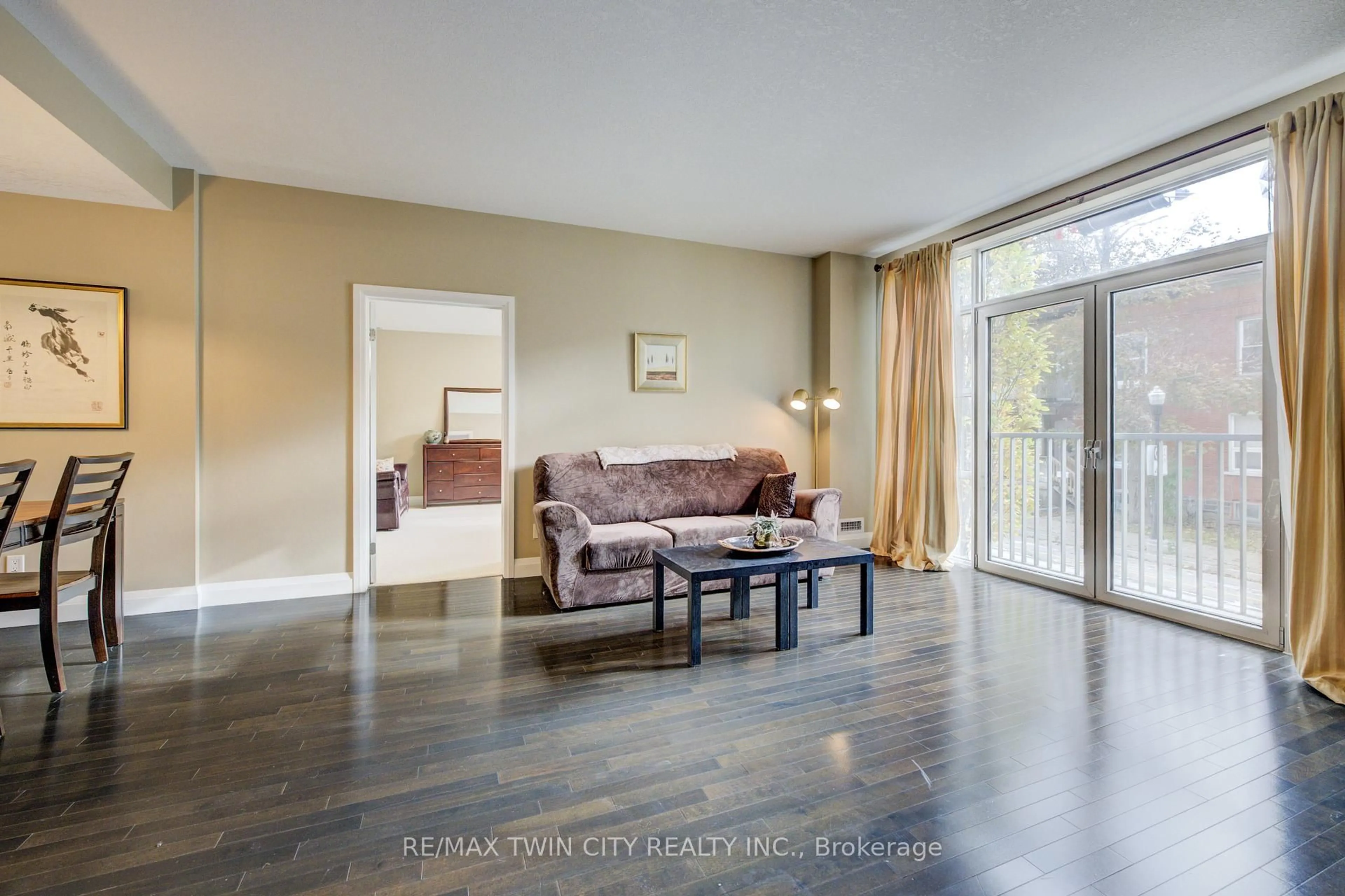 Living room with furniture, wood/laminate floor for 165 Duke St #105, Kitchener Ontario N2H 6T8