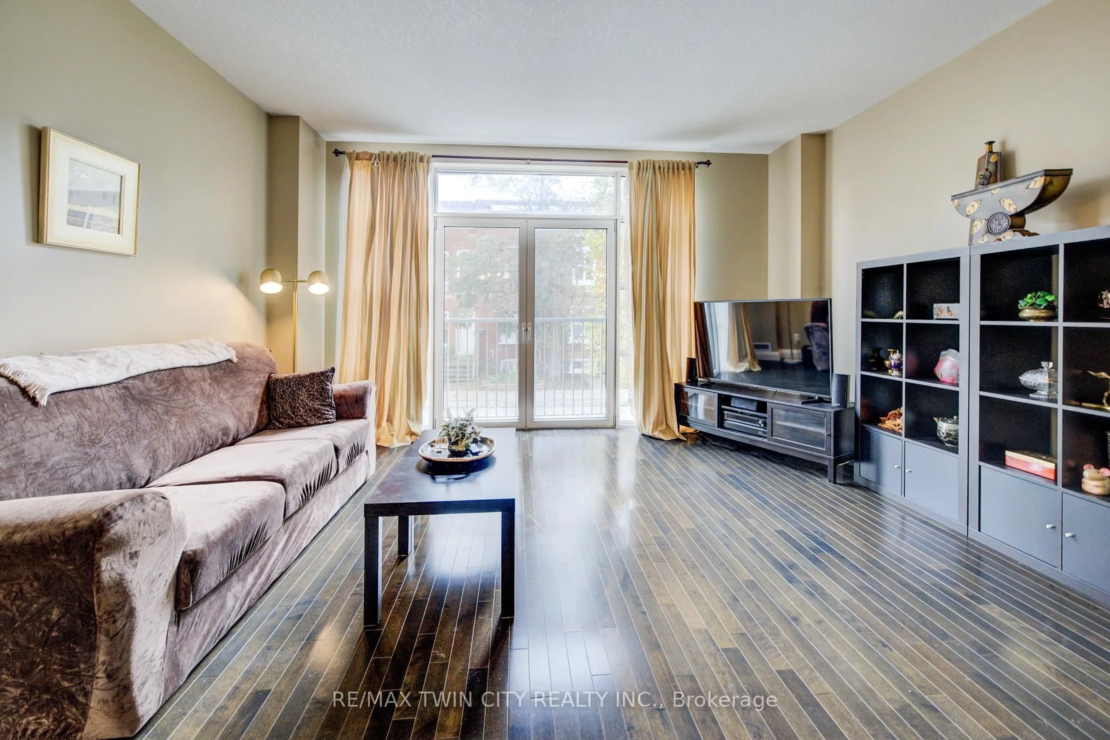 Living room with furniture, wood/laminate floor for 165 Duke St #105, Kitchener Ontario N2H 6T8