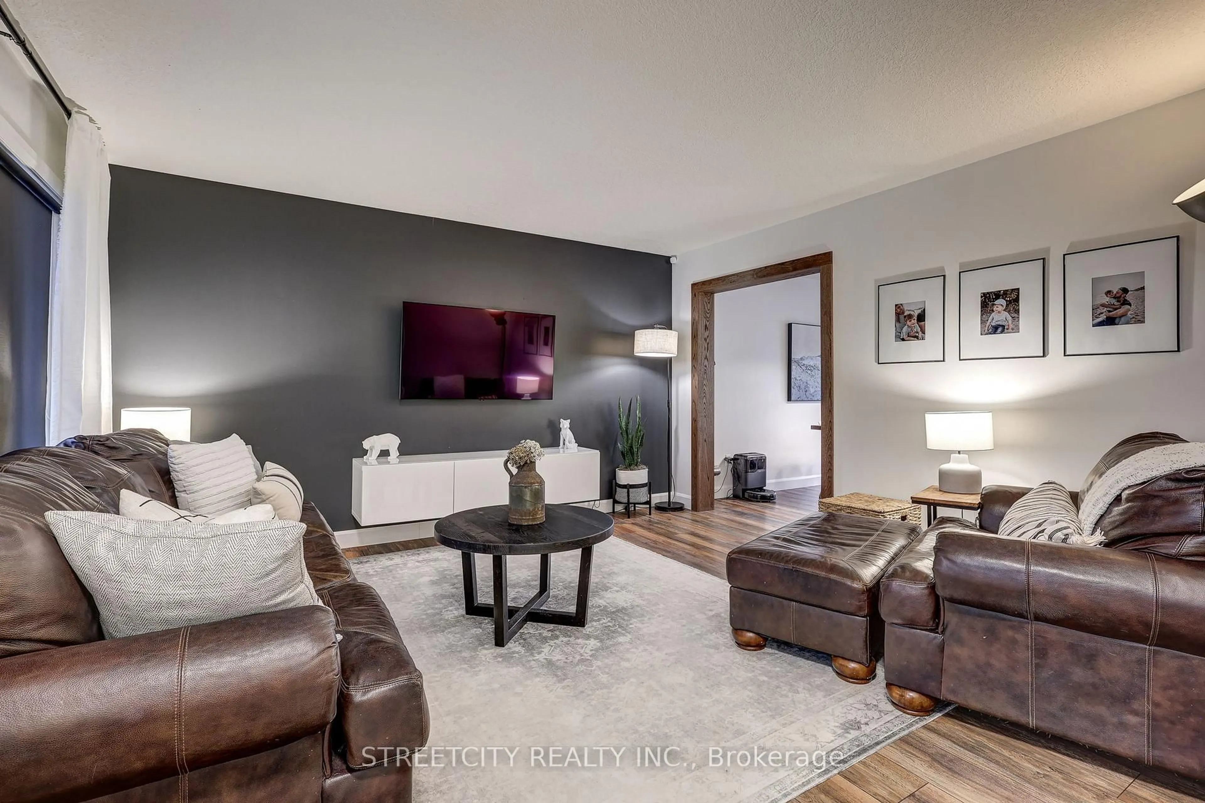 Living room with furniture, wood/laminate floor for 105 Penhale Ave, St. Thomas Ontario N5R 6M3