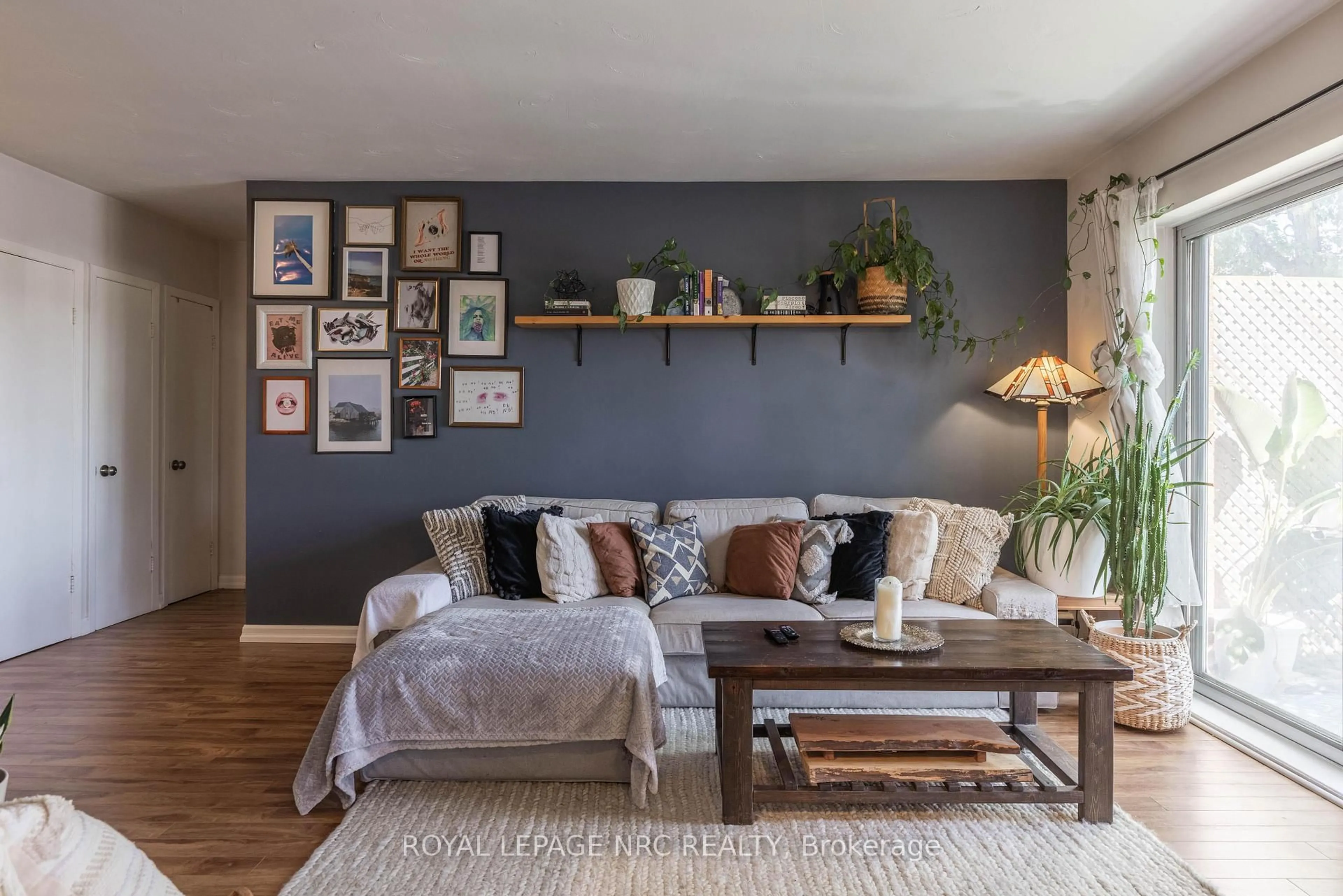 Living room with furniture, wood/laminate floor for 456 Carlton St #34, St. Catharines Ontario L2M 4X1