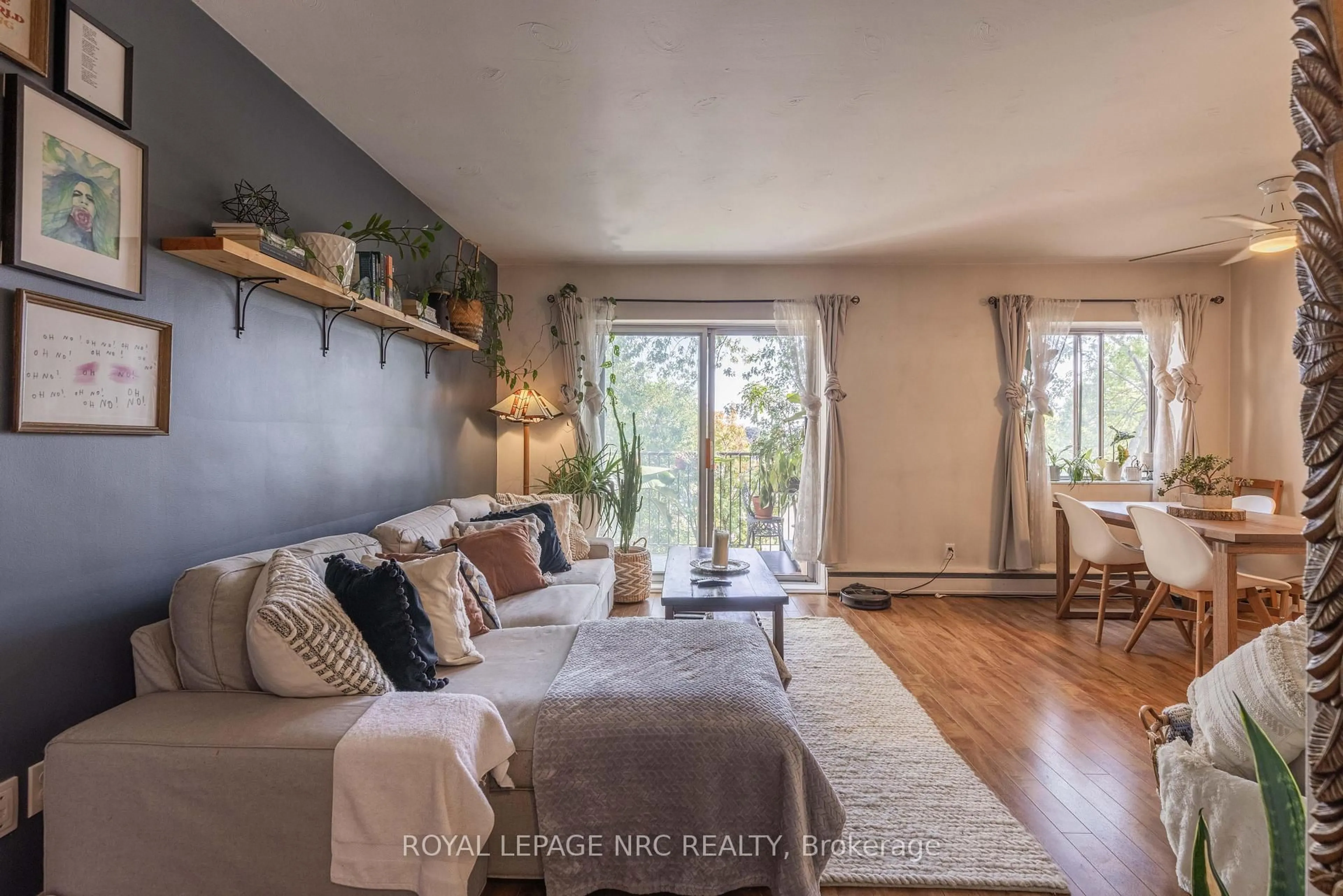 Living room with furniture, wood/laminate floor for 456 Carlton St #34, St. Catharines Ontario L2M 4X1