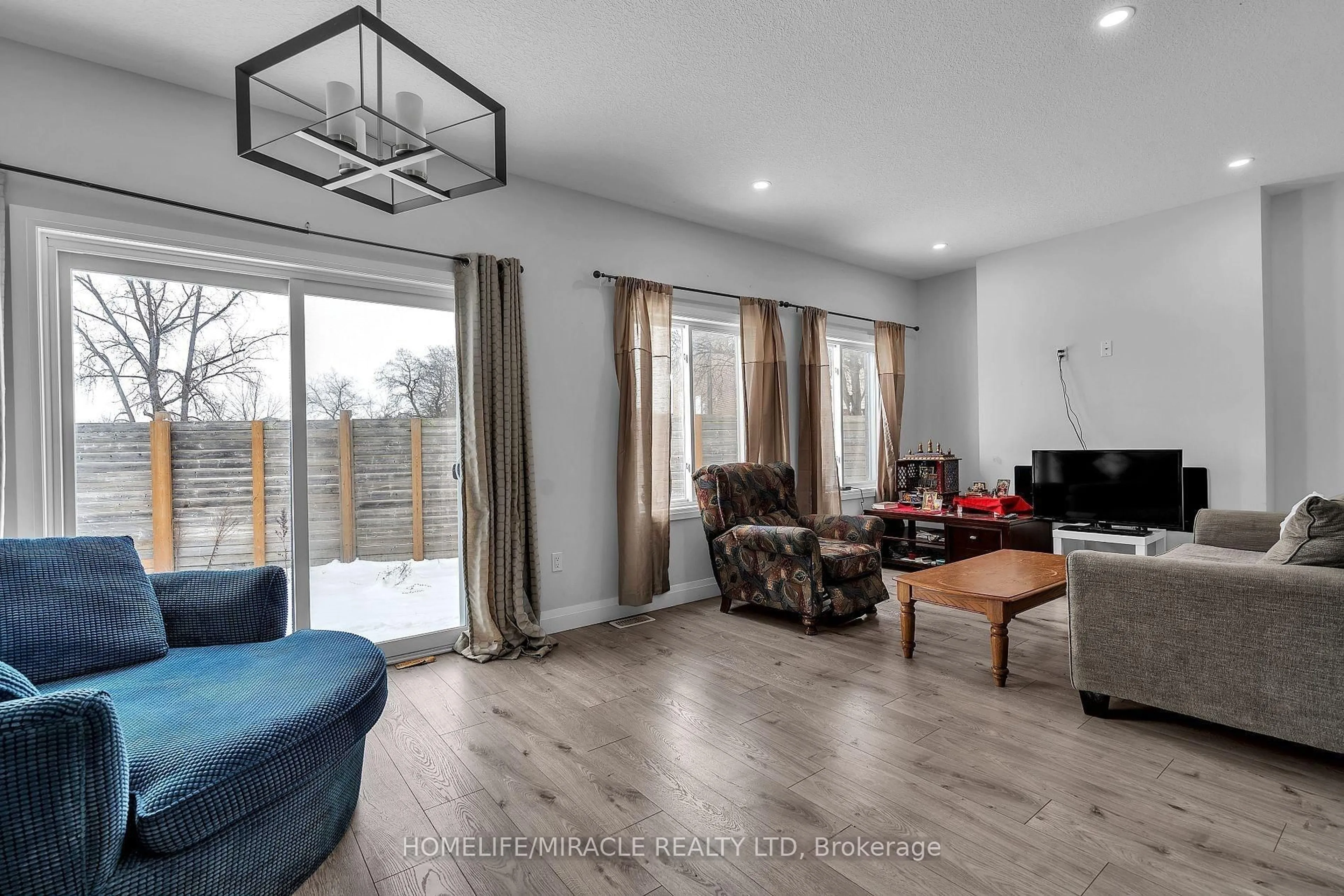 Living room with furniture, wood/laminate floor for 121 Marconi Crt, London East Ontario N5V 0C9