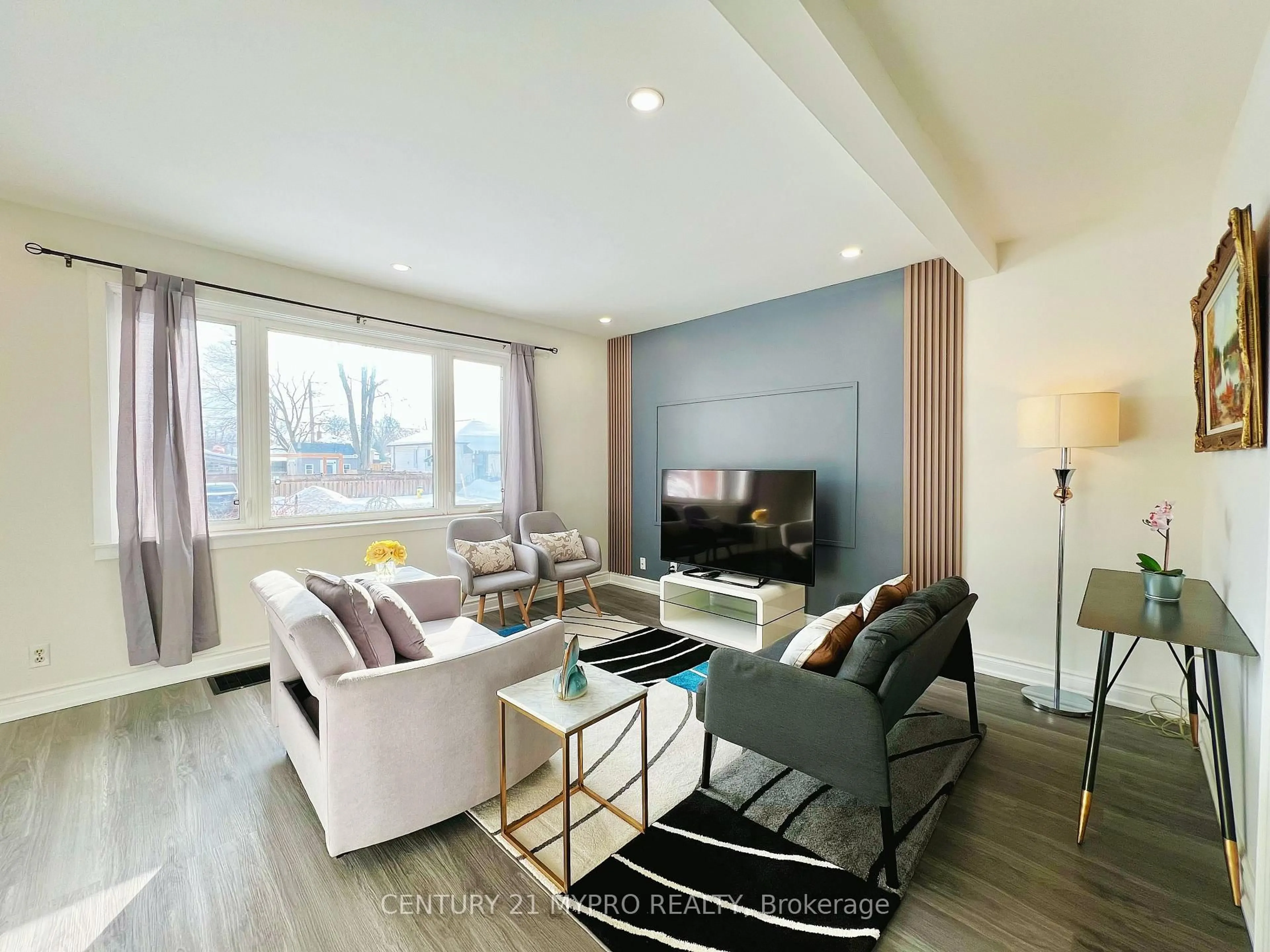 Living room with furniture, wood/laminate floor for 448 Hamilton St, Peterborough Ontario K9J 4B9