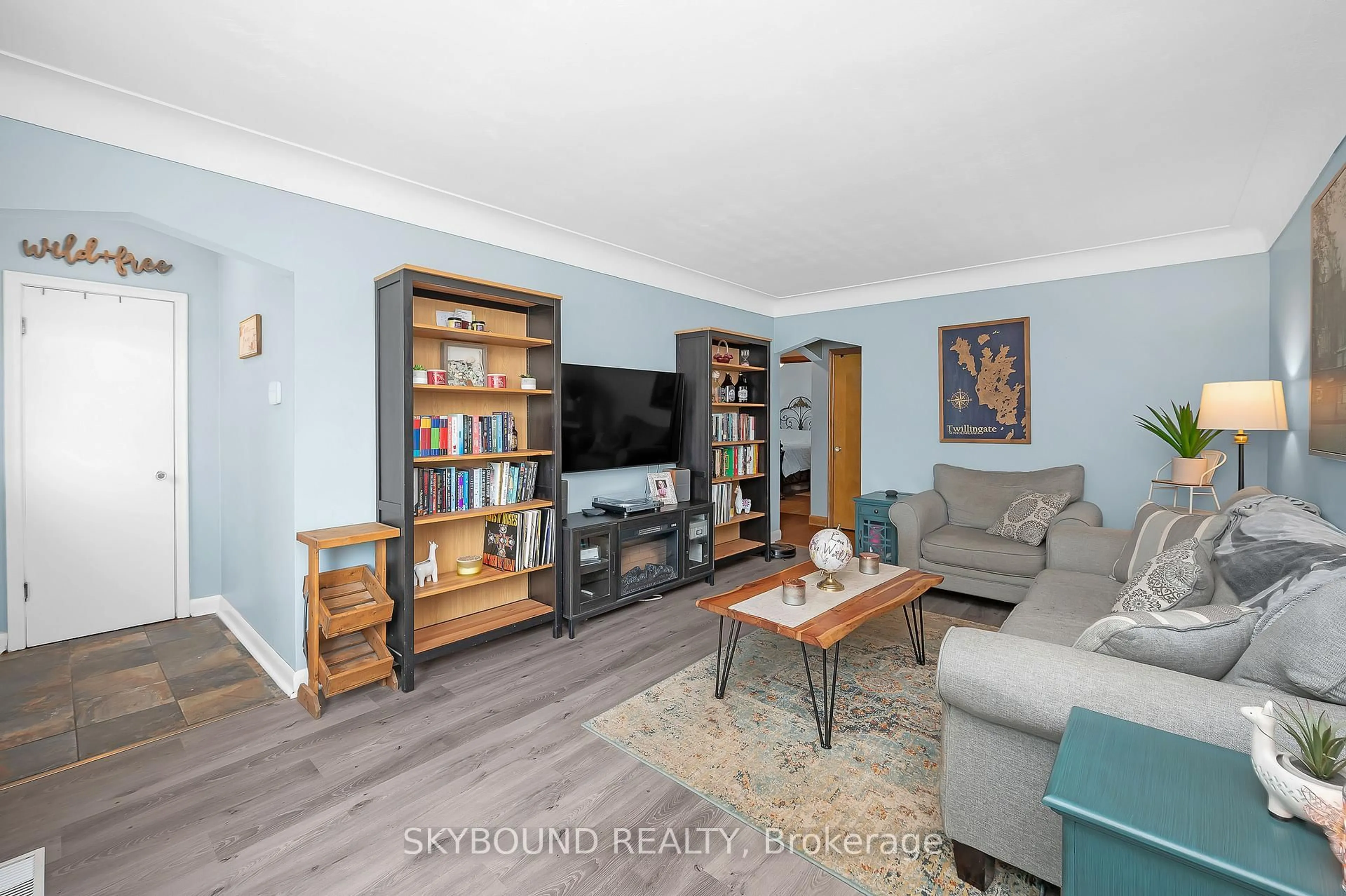 Living room with furniture, wood/laminate floor for 103 McElroy Rd, Hamilton Ontario L9A 1Y7