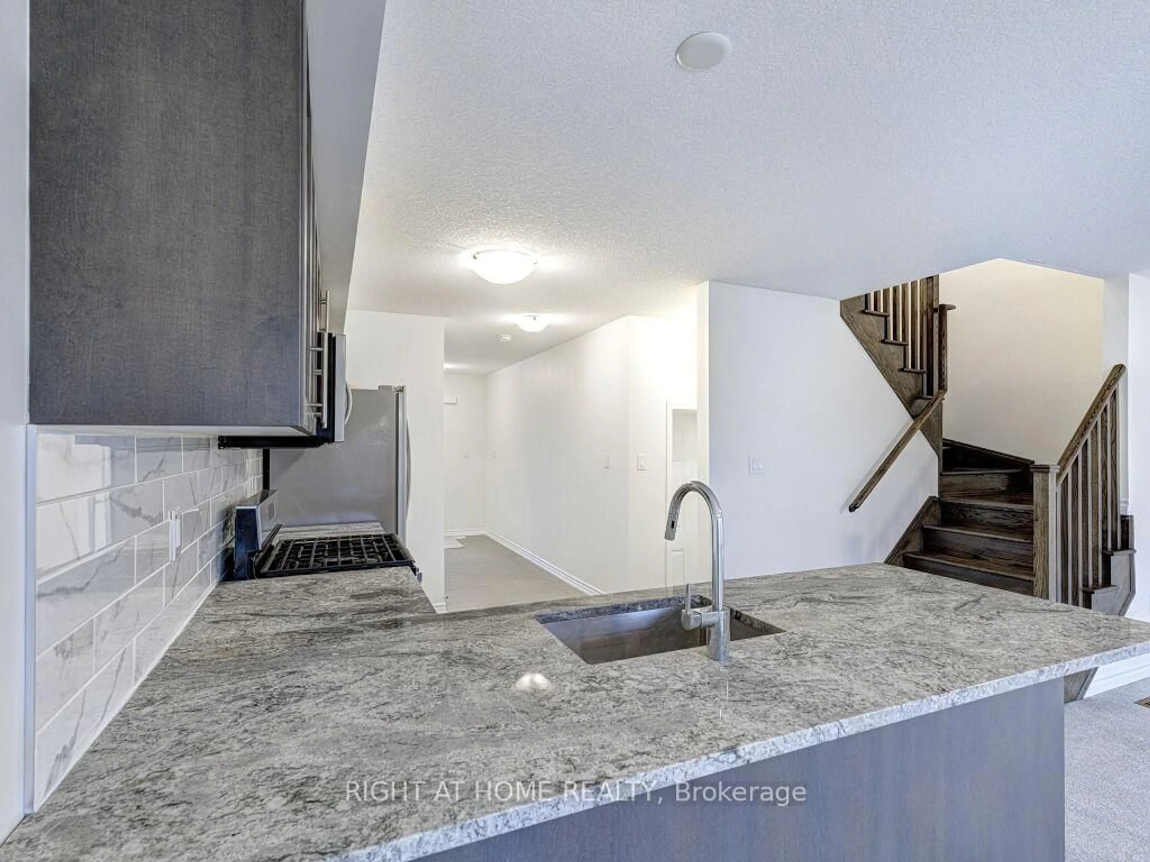 Open concept kitchen, cement floor for 121 Scarletwood St, Hamilton Ontario L8J 0K8