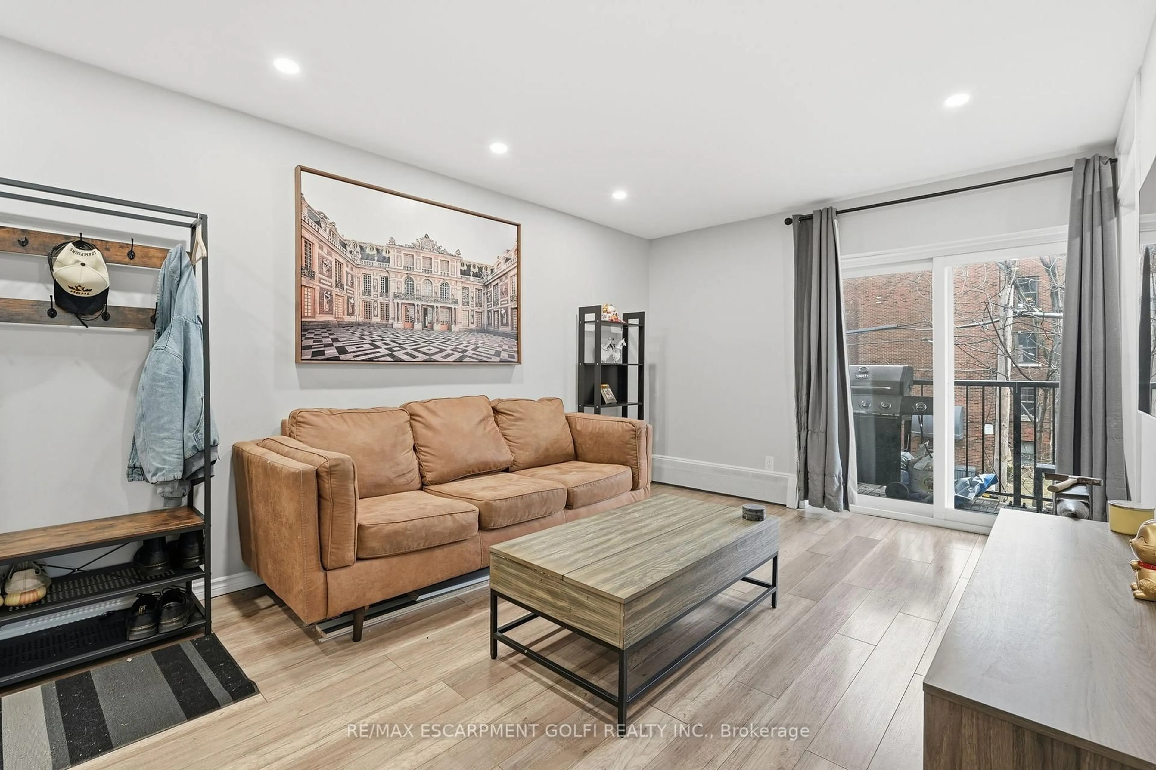 Living room with furniture, wood/laminate floor for 40 Robinson St #308, Hamilton Ontario L8P 1Y9