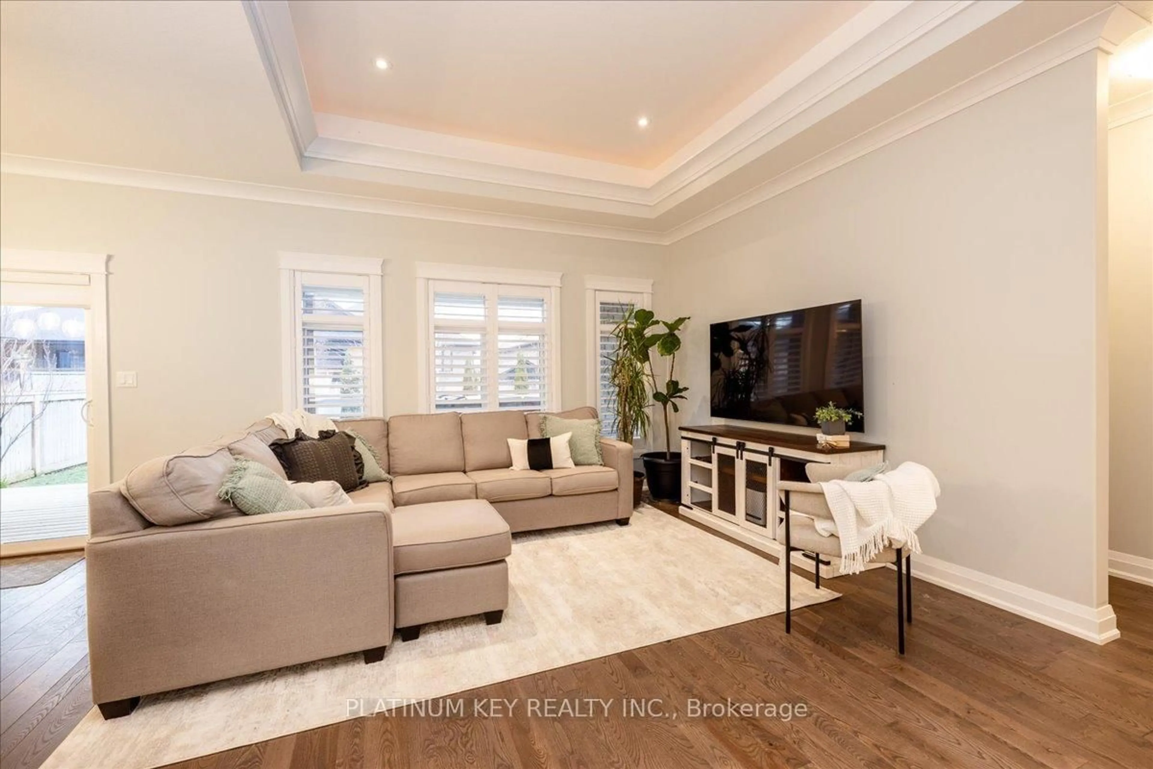 Living room with furniture, wood/laminate floor for 88 Collins Way, Strathroy-Caradoc Ontario N7G 0G2