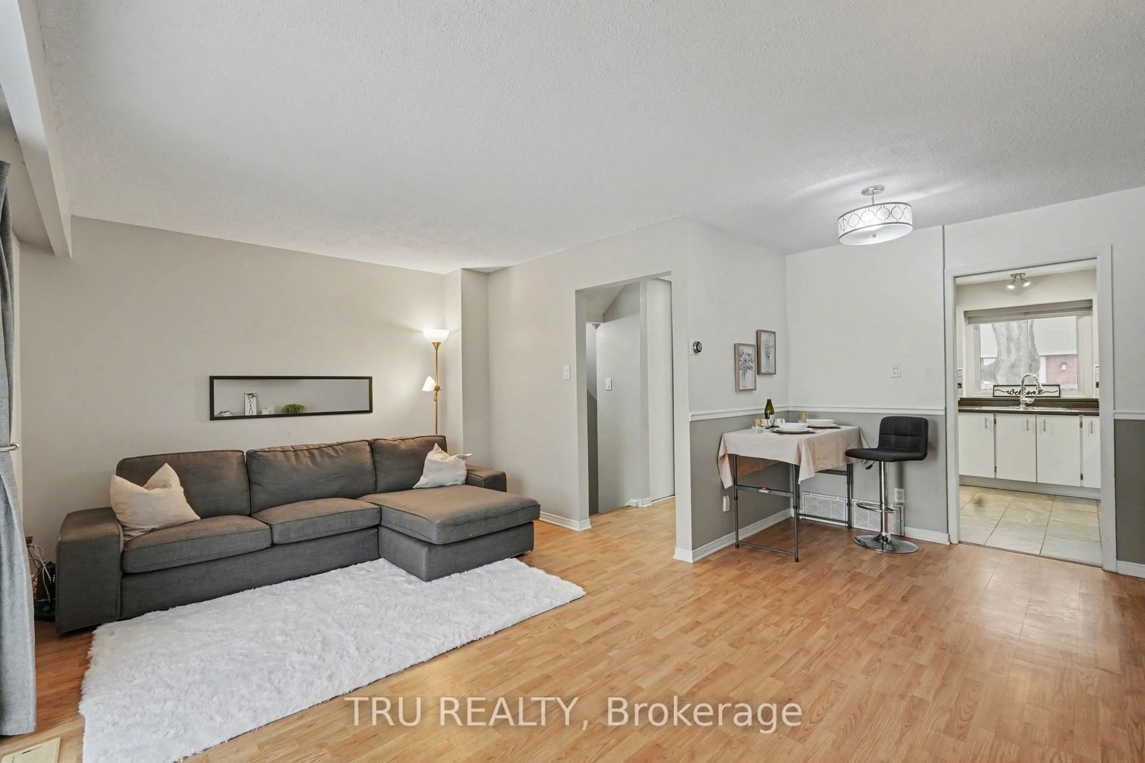 Living room with furniture, wood/laminate floor for 463F Moodie Dr, Ottawa Ontario K2H 8T7