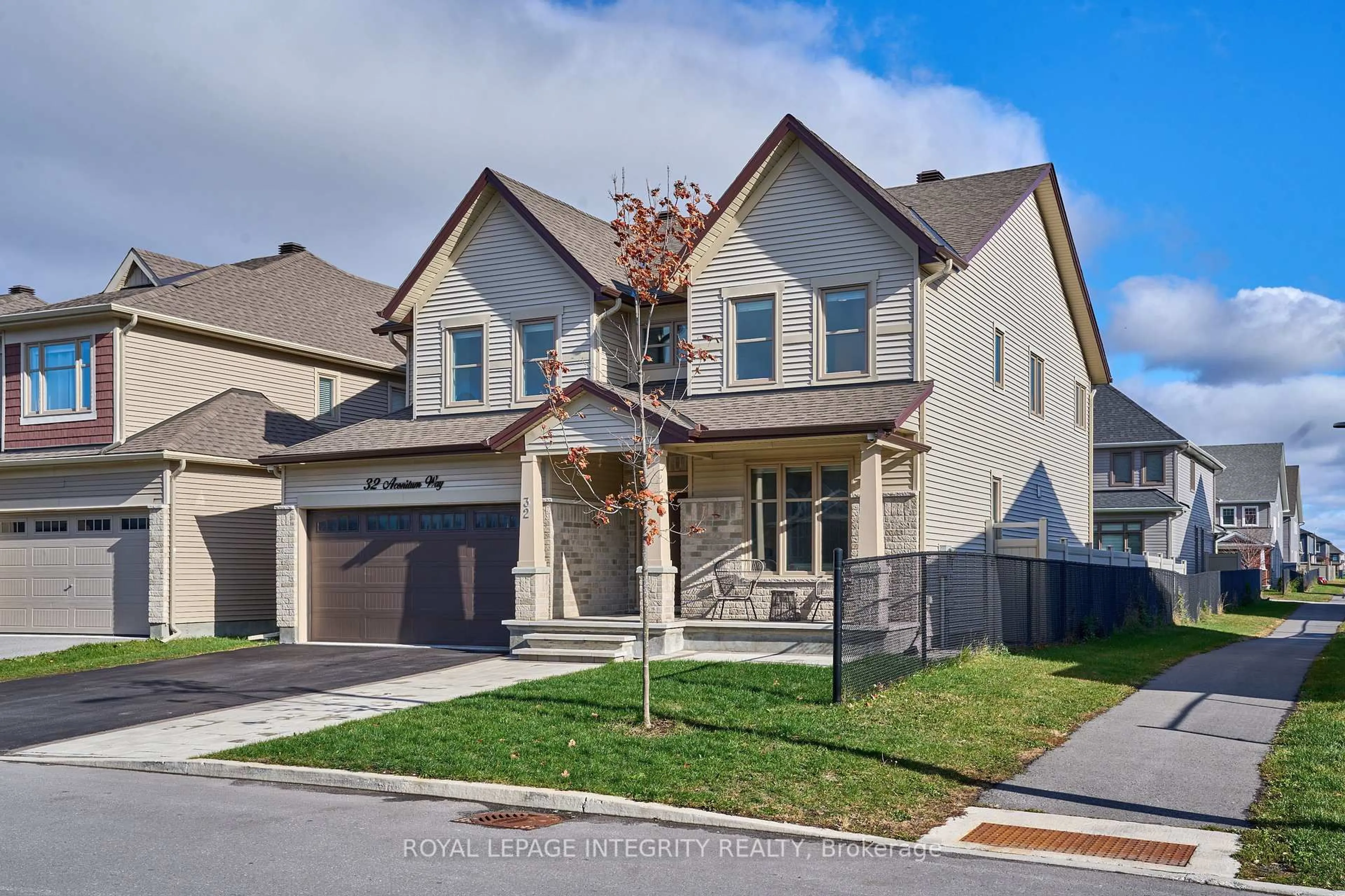 Home with brick exterior material, street for 32 Aconitum Way, Ottawa Ontario K1T 0S1
