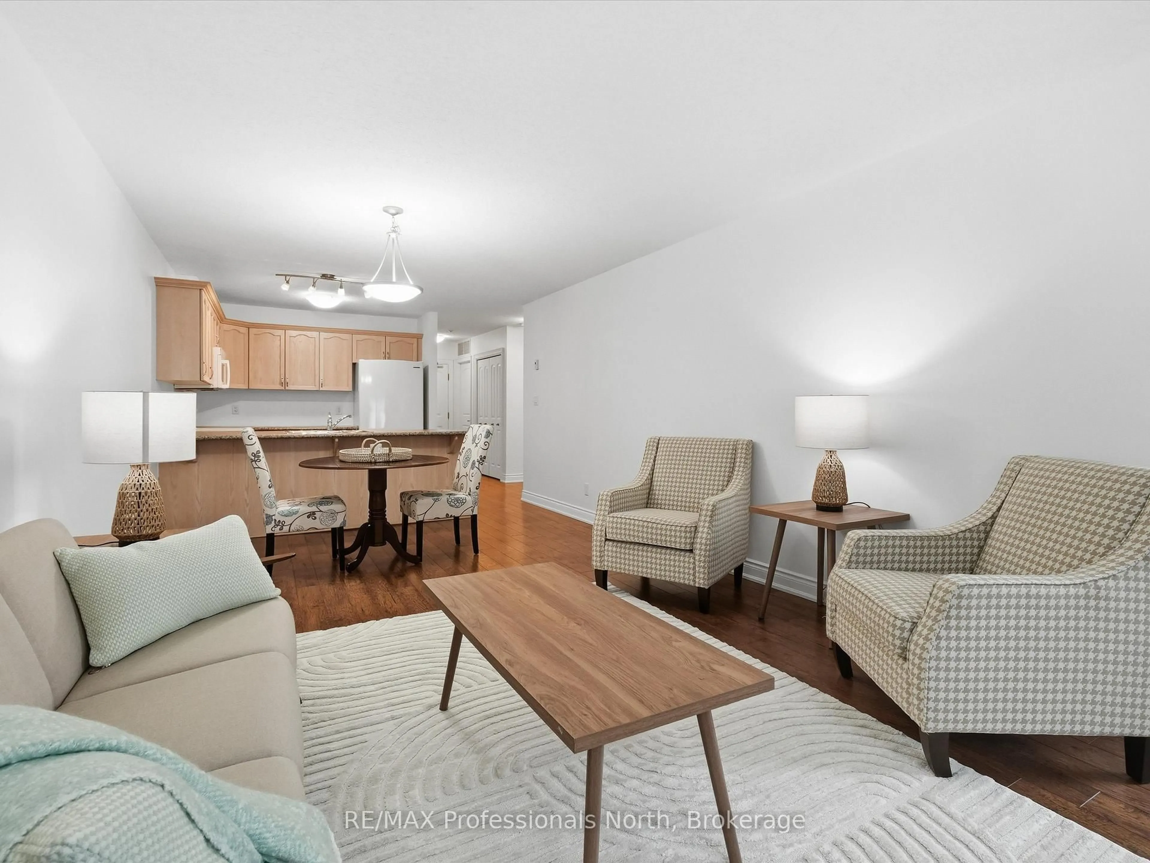 Living room with furniture, wood/laminate floor for 10A Kimberley Ave #206, Bracebridge Ontario P1L 0A6