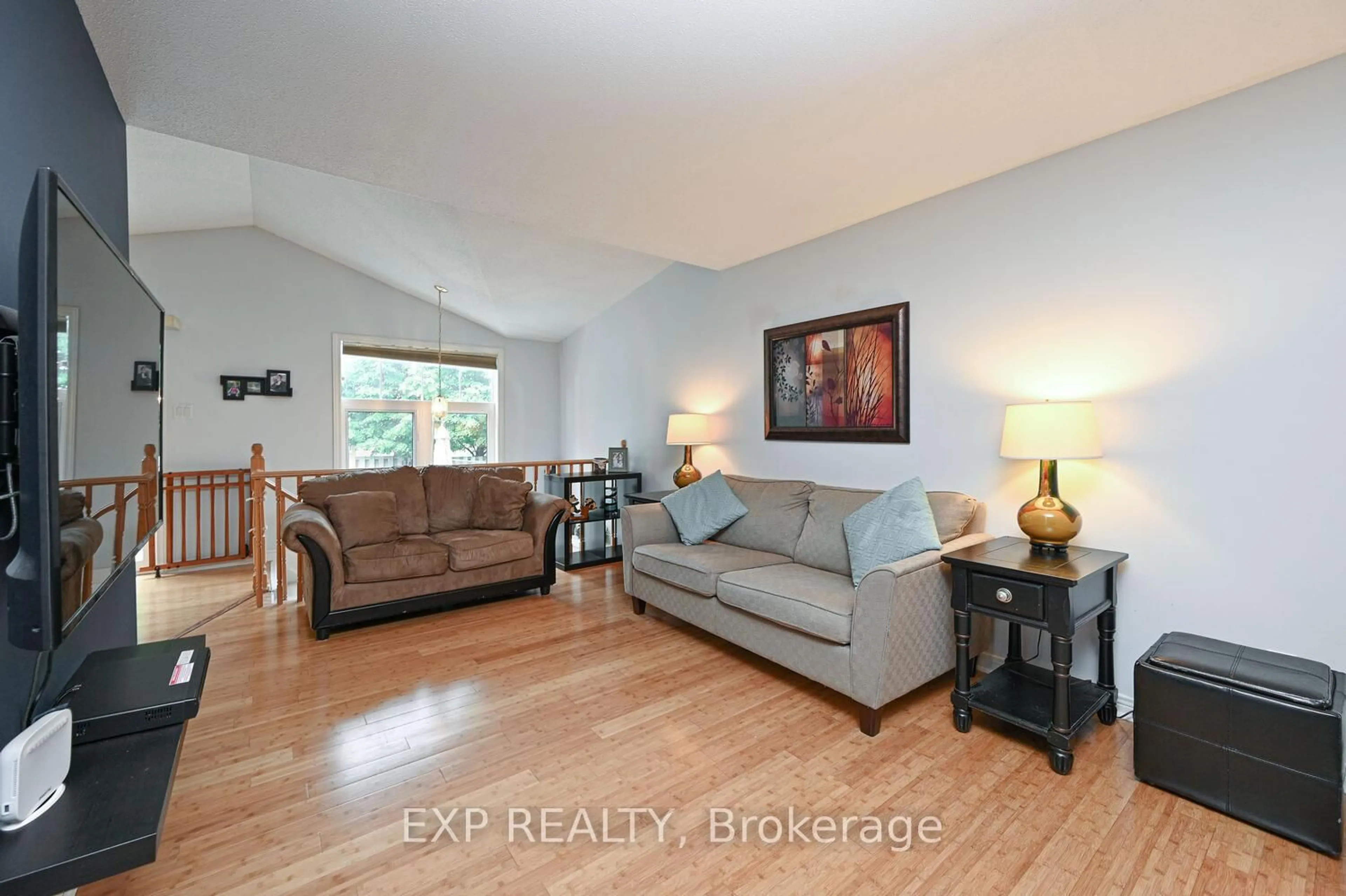 Living room with furniture, wood/laminate floor for 677 Wildshore Cres, Ottawa Ontario K1V 1Y1