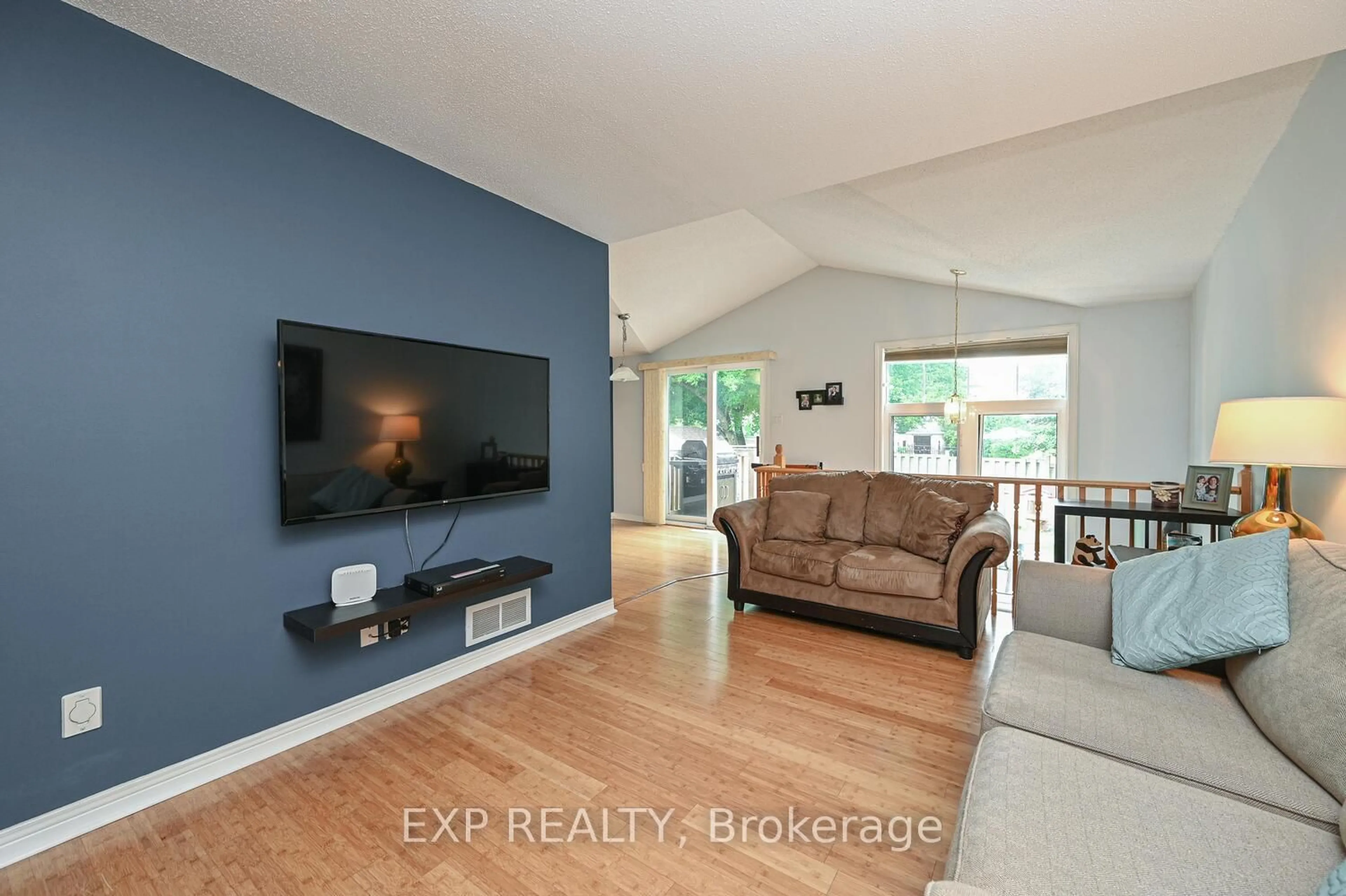 Living room with furniture, wood/laminate floor for 677 Wildshore Cres, Ottawa Ontario K1V 1Y1