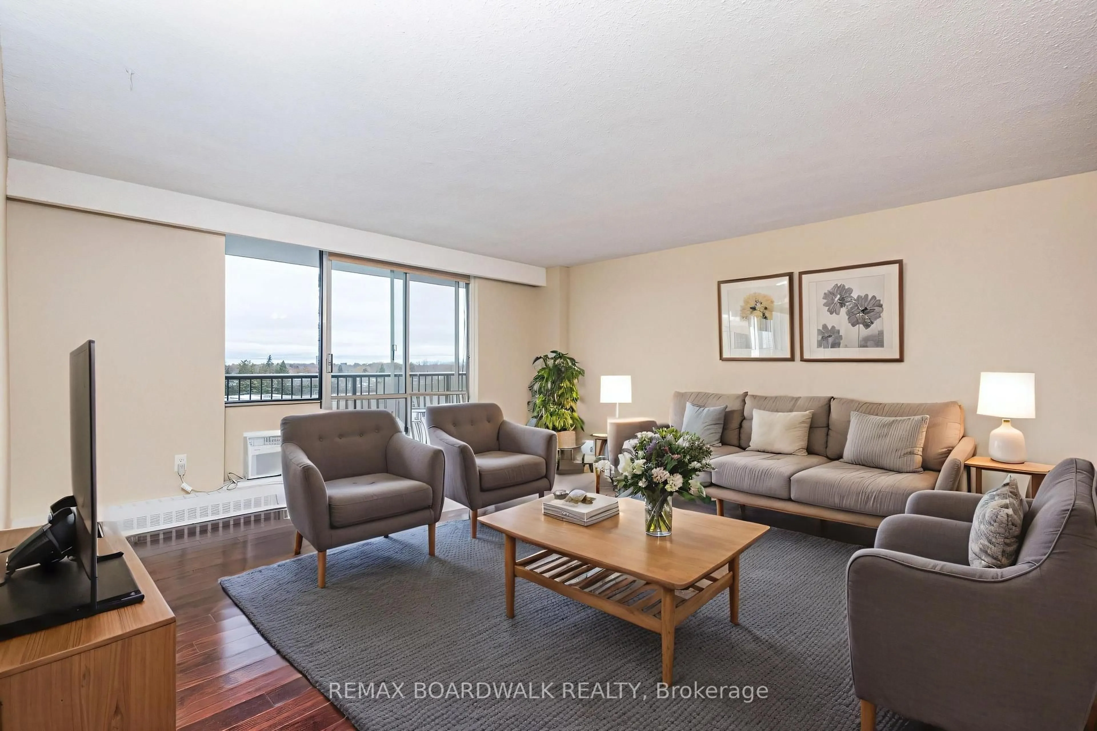 Living room with furniture, wood/laminate floor for 2400 Virginia Dr #709, Ottawa Ontario K1H 8L3