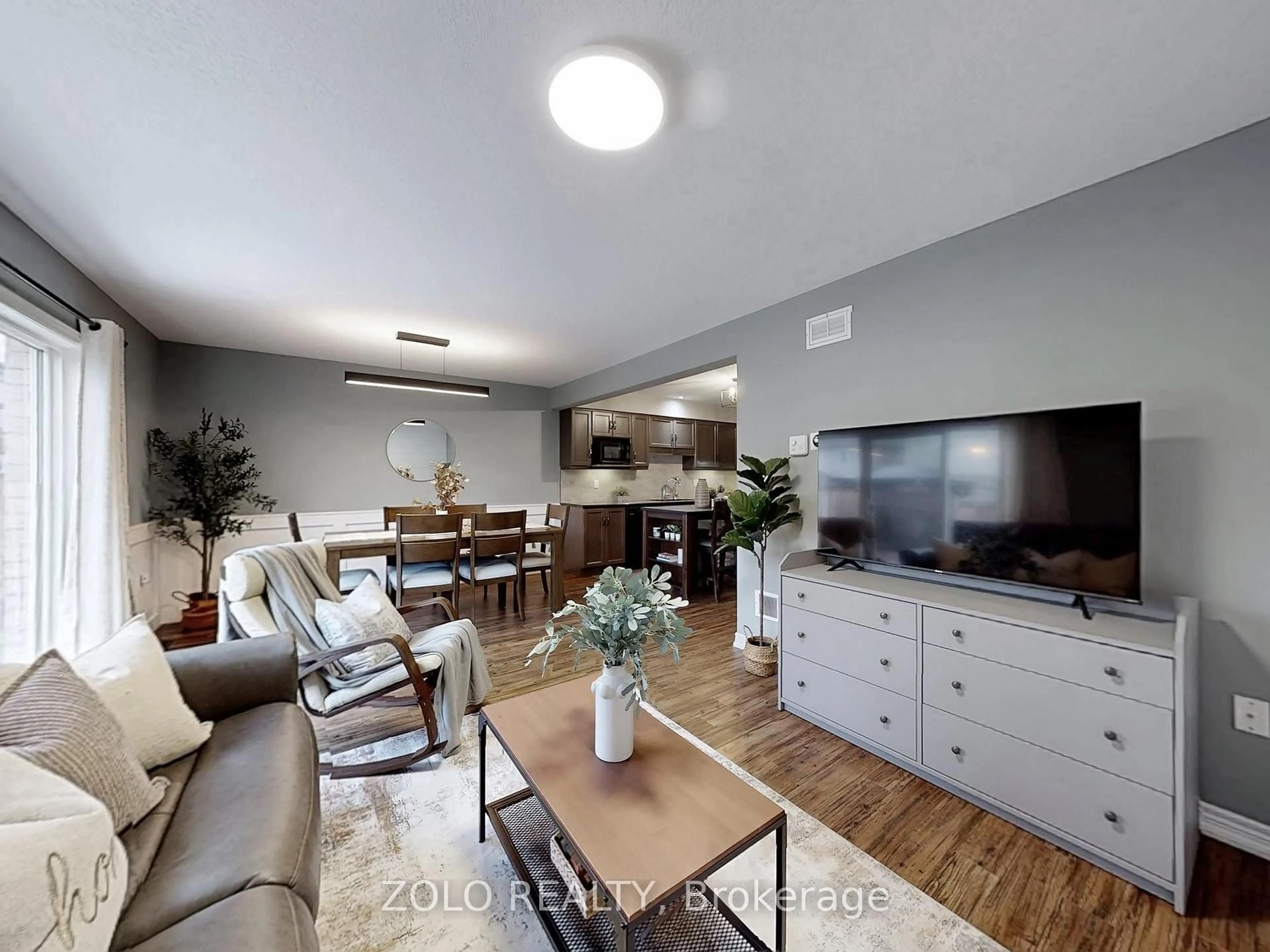 Living room with furniture, wood/laminate floor for 33 Marshall Dr, Guelph Ontario N1E 0K7