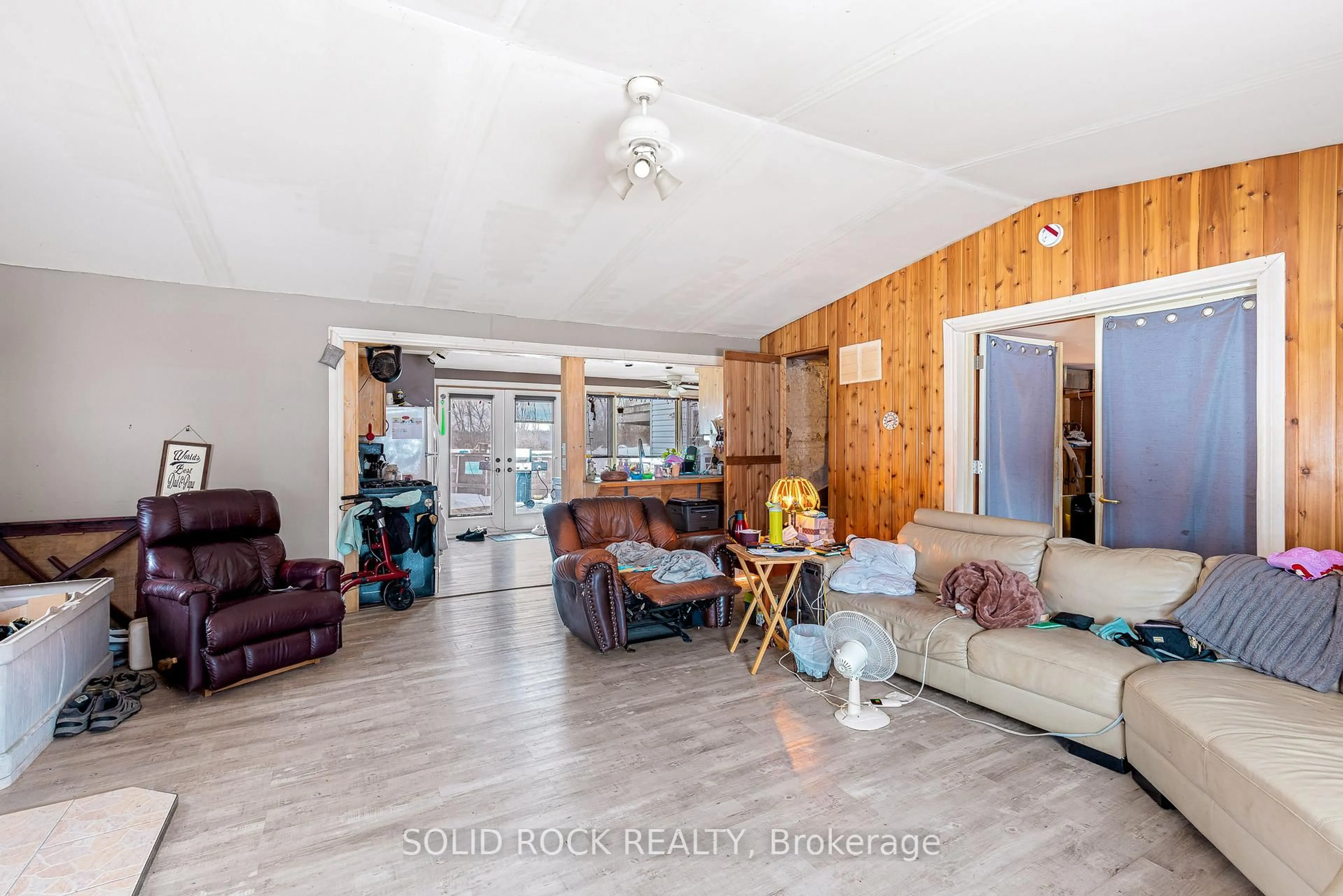 Living room with furniture, wood/laminate floor for 1447 County 2 Rd, Front of Yonge Ontario K0E 1R0