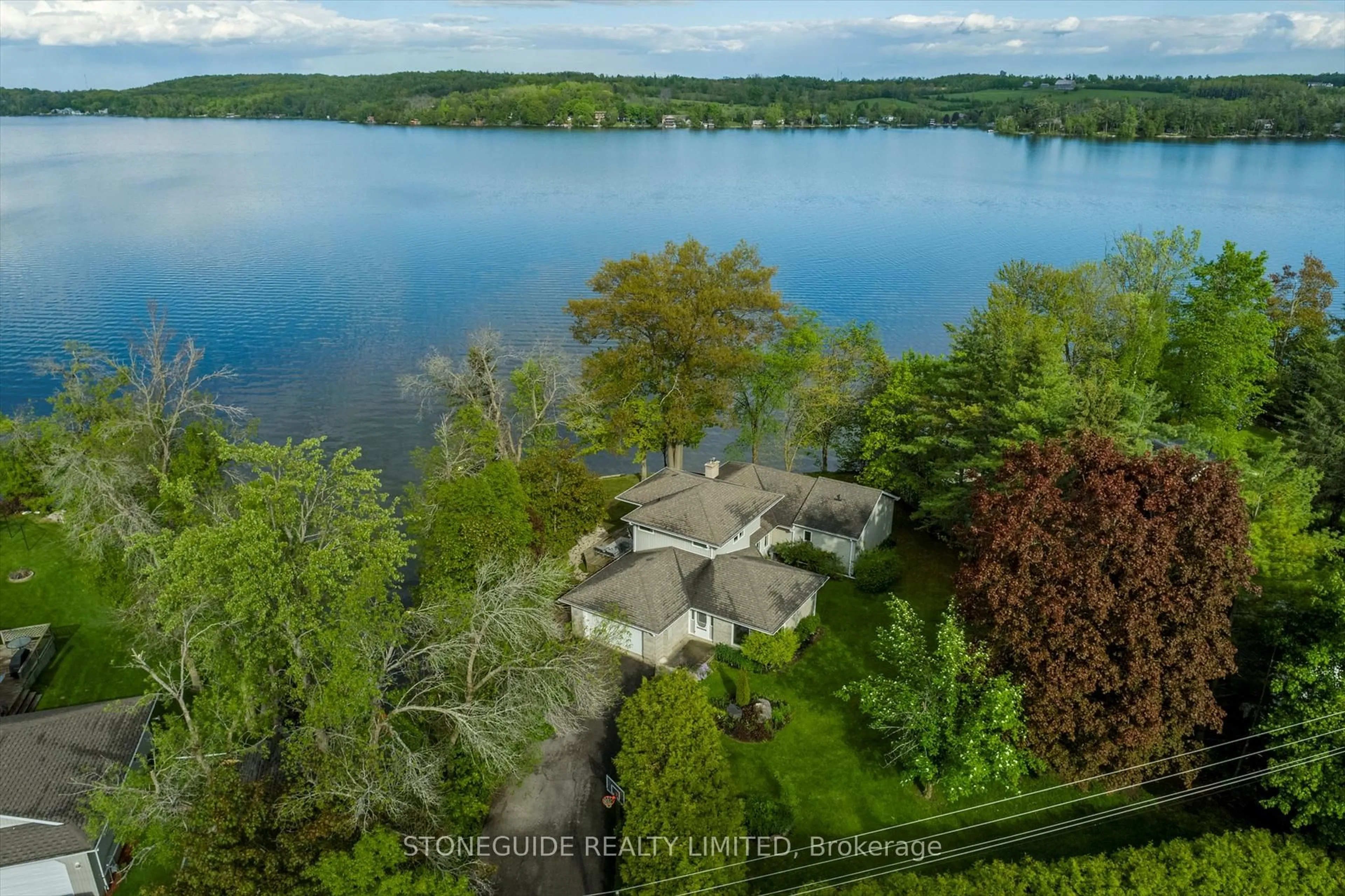 A pic from outside/outdoor area/front of a property/back of a property/a pic from drone, water/lake/river/ocean view for 409 Gifford Dr, Selwyn Ontario K9J 6X2
