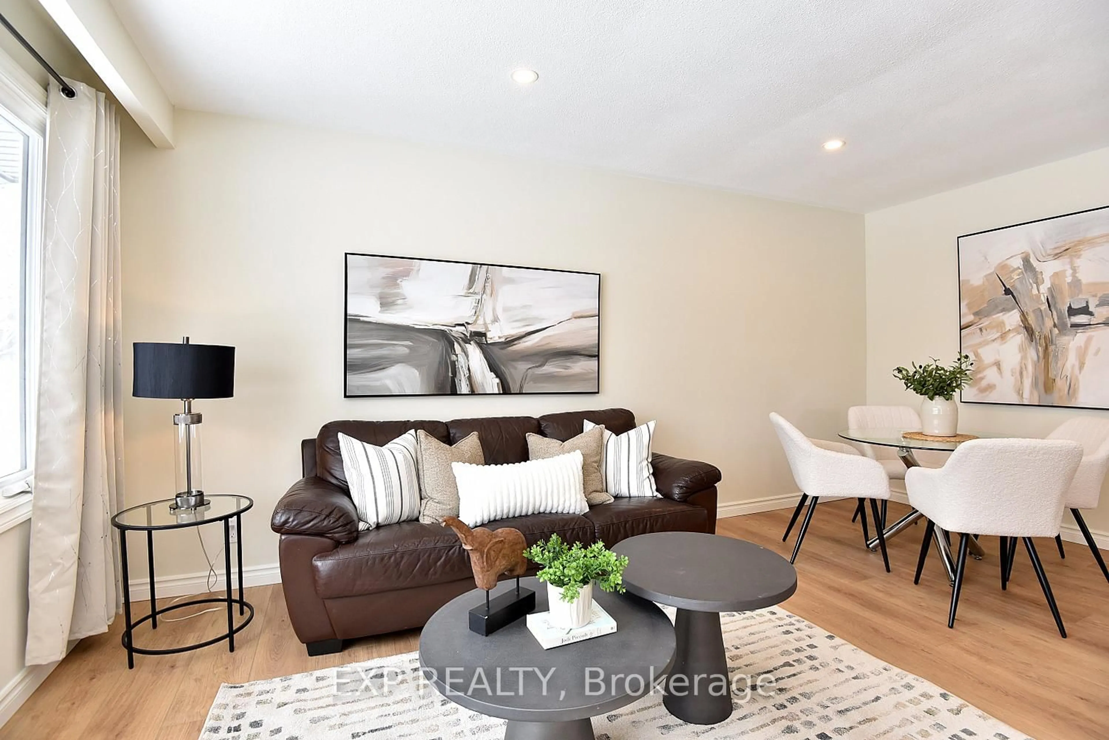 Living room with furniture, wood/laminate floor for 47 Odessa St, Hamilton Ontario L8J 1A3