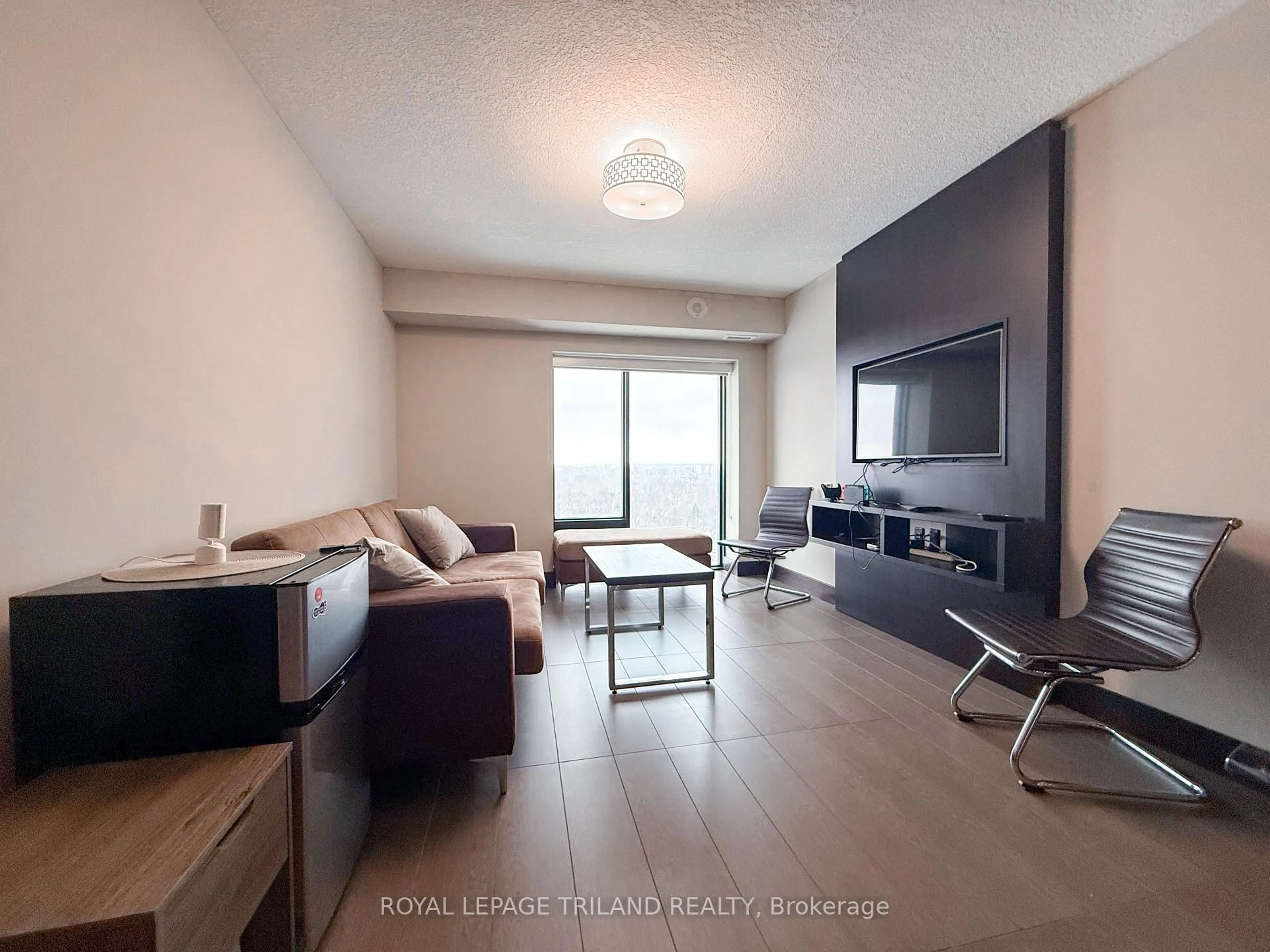 Living room with furniture, wood/laminate floor for 1235 RICHMOND St #1514, London East Ontario N6A 0C1