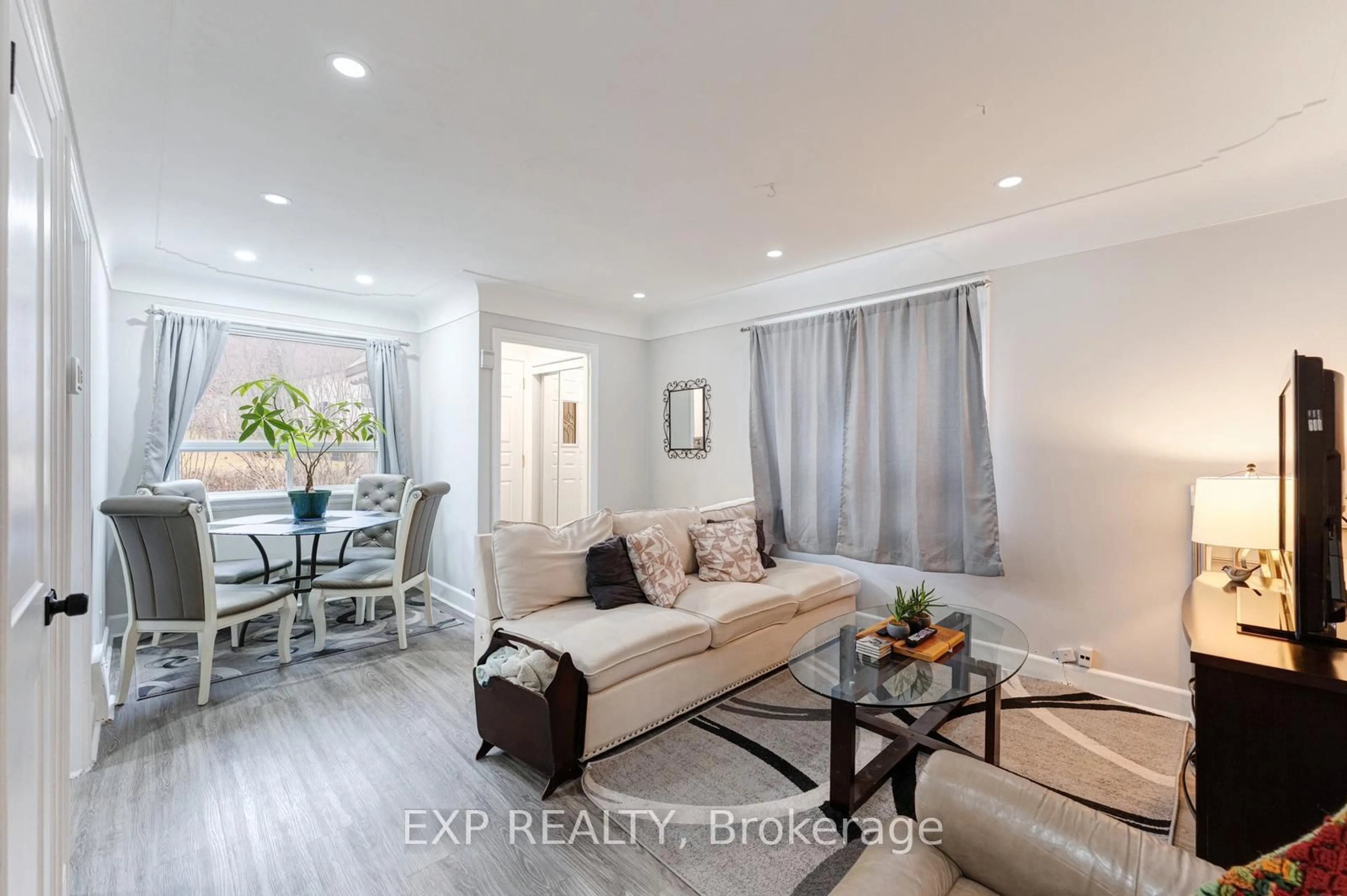 Living room with furniture, wood/laminate floor for 16 Ainslie Ave, Hamilton Ontario L8S 2J3