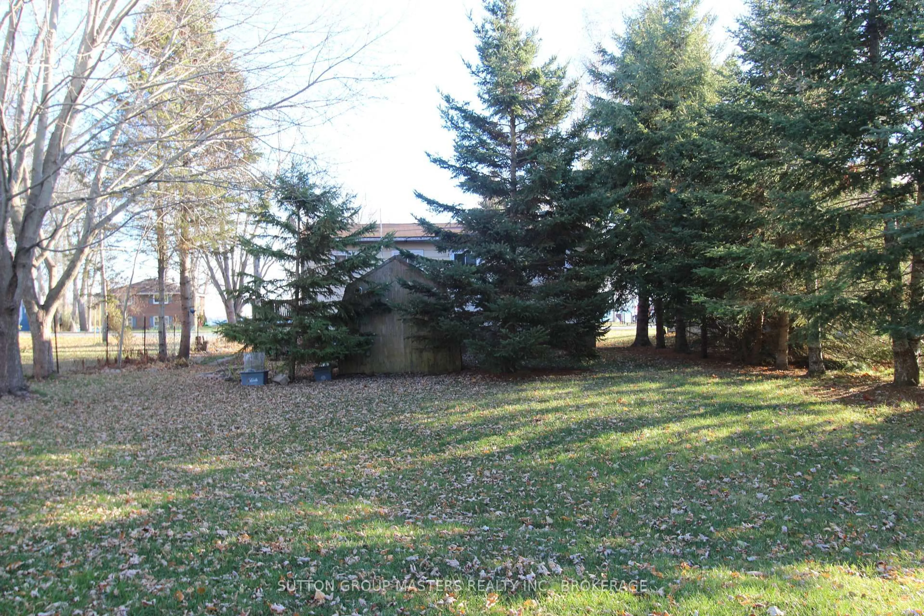 A pic from outside/outdoor area/front of a property/back of a property/a pic from drone, forest/trees view for 304 Main St, Bath Ontario K0H 1G0