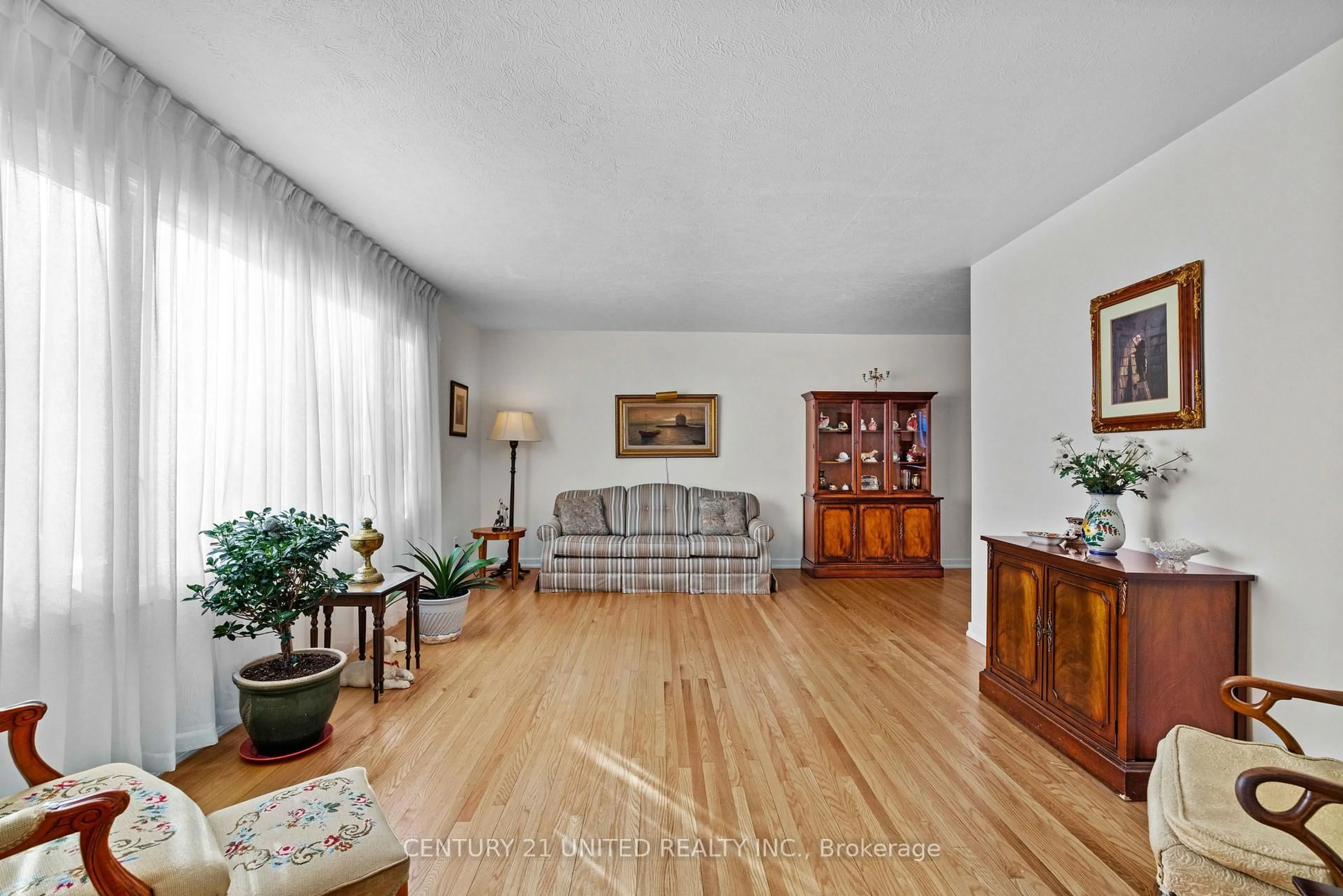 Living room with furniture, wood/laminate floor for 852 Parkhill Rd, Peterborough Ontario K9J 6P1