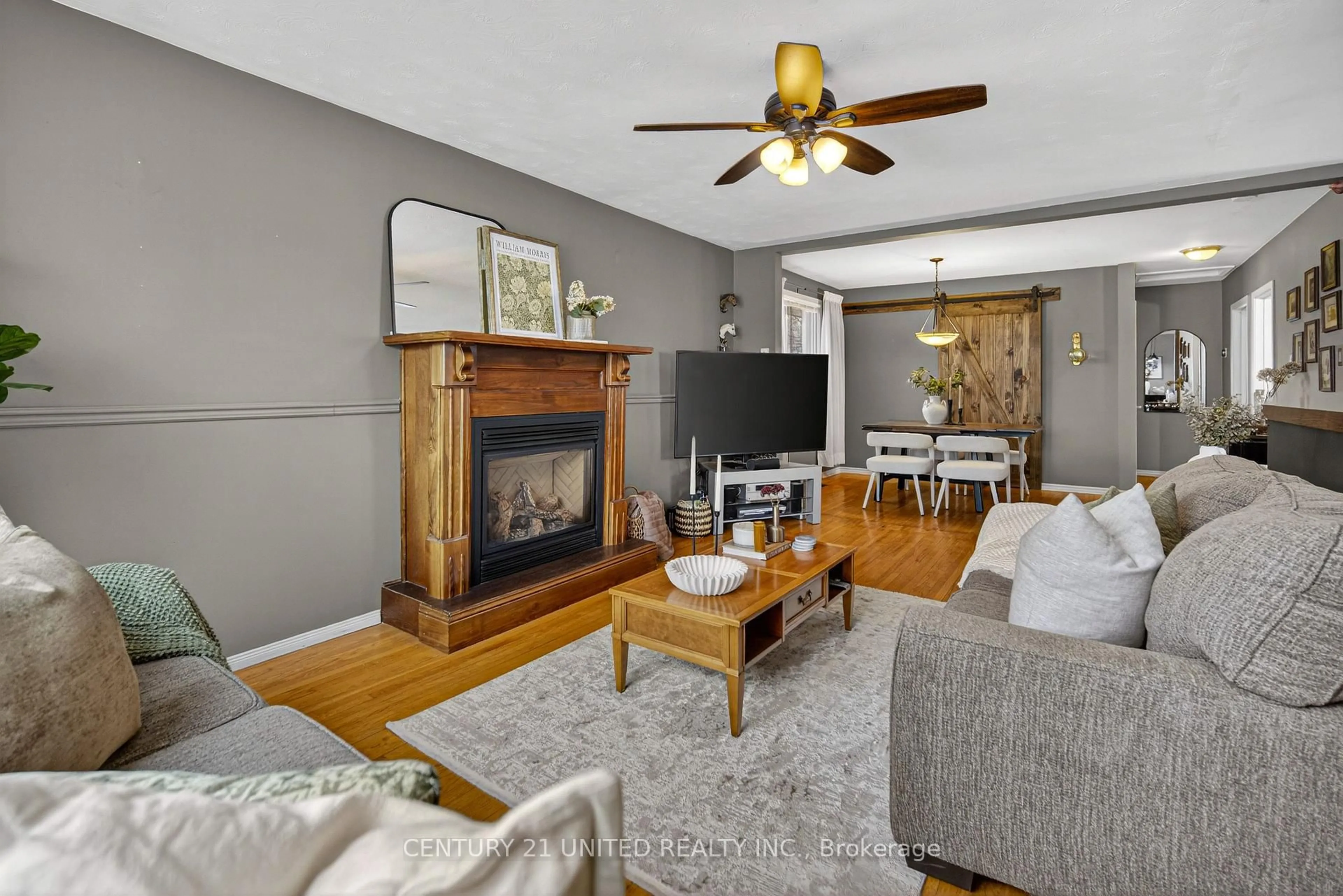 Living room with furniture, wood/laminate floor for 794 Foxe St, Peterborough Ontario K9H 6Y7