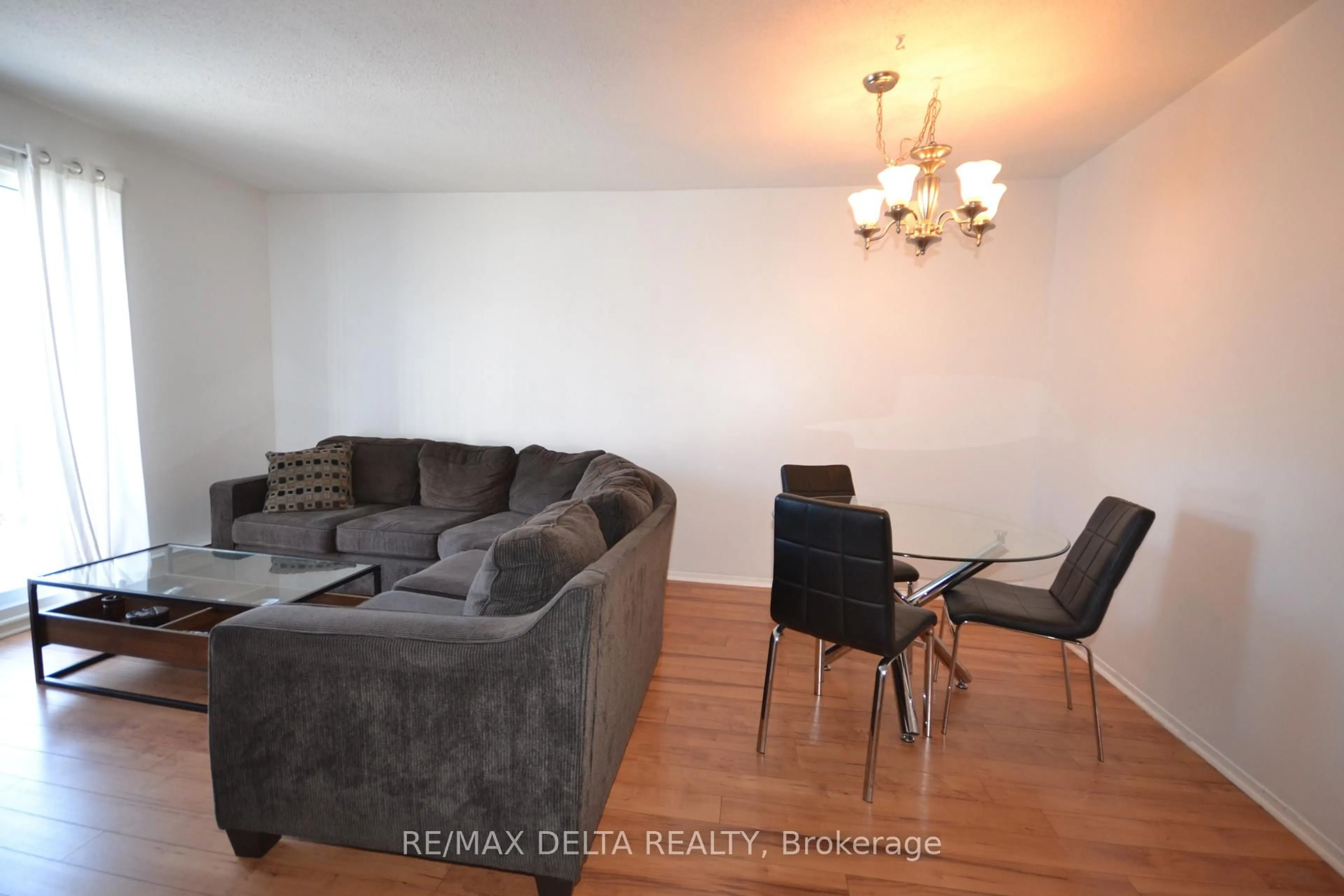 Living room with furniture, wood/laminate floor for 325 Centrum Blvd #412, Ottawa Ontario K1E 3W8