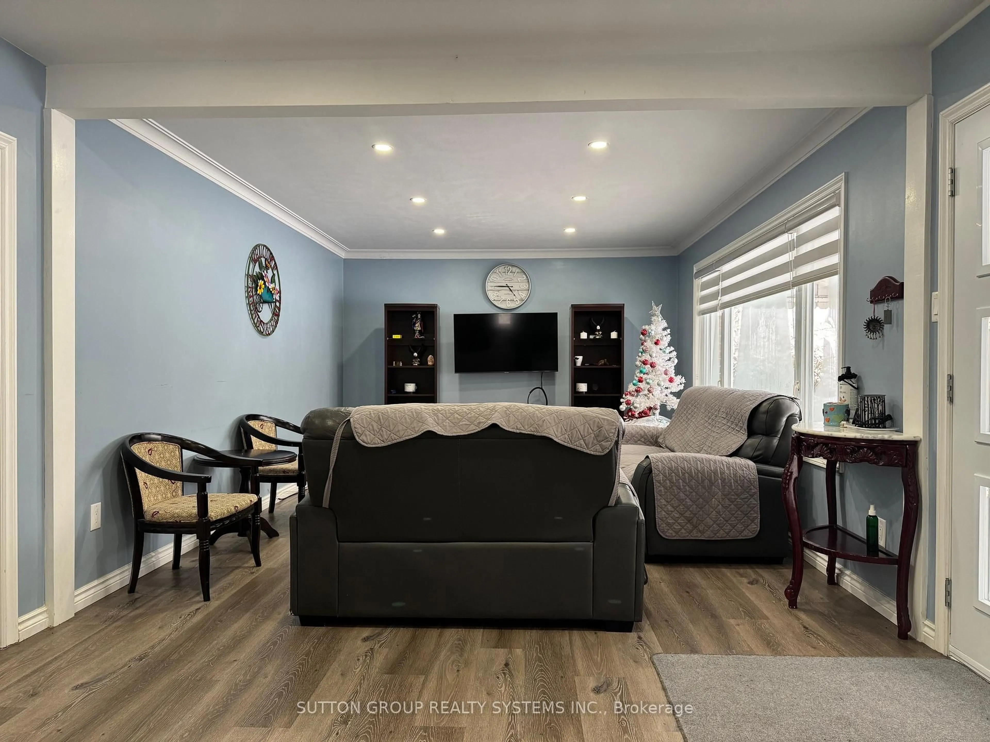 Living room with furniture, wood/laminate floor for 1338 Royal Dr, Peterborough Ontario K9H 6R8