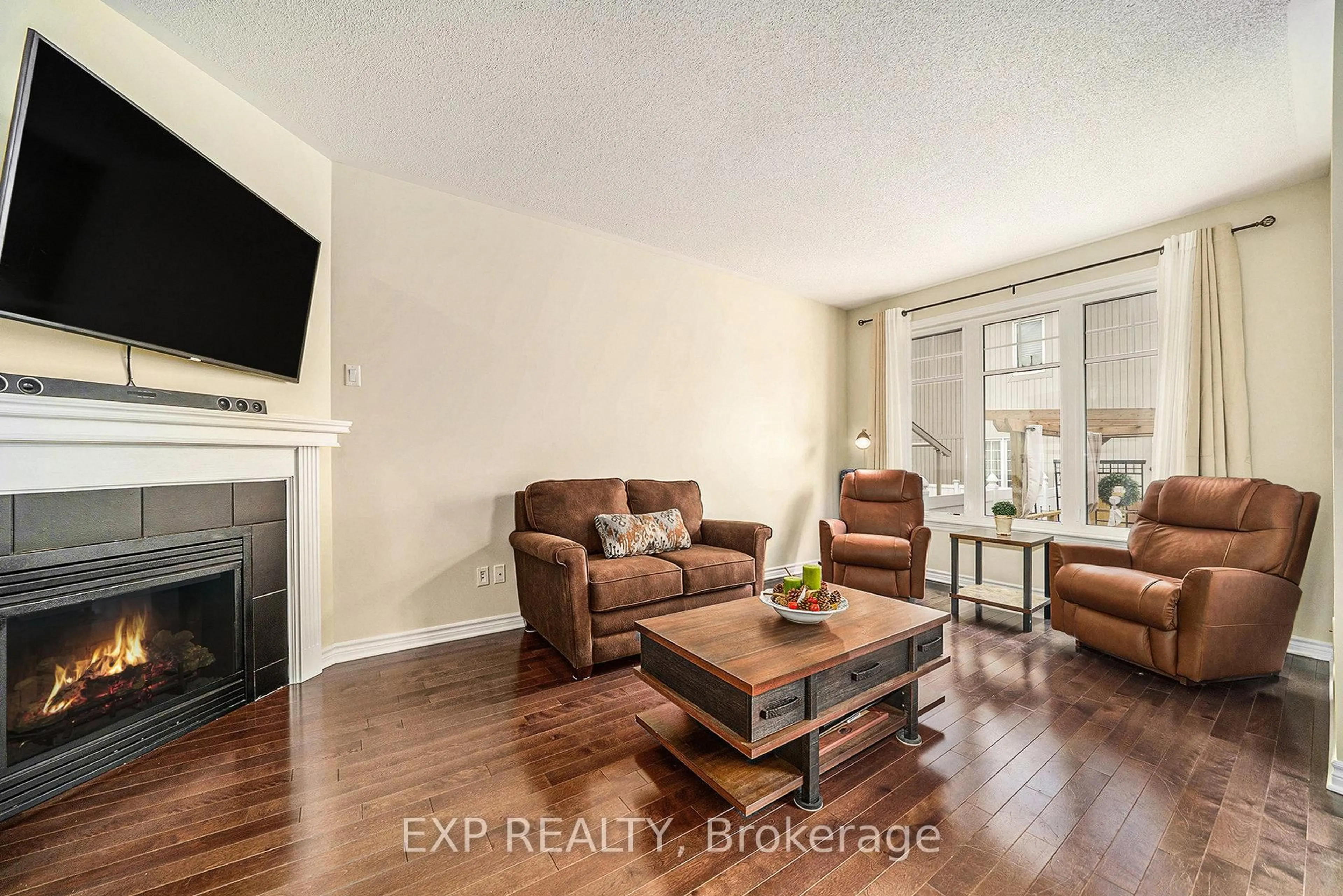 Living room with furniture, wood/laminate floor for 203 Brambling Way, Ottawa Ontario K2J 5V5